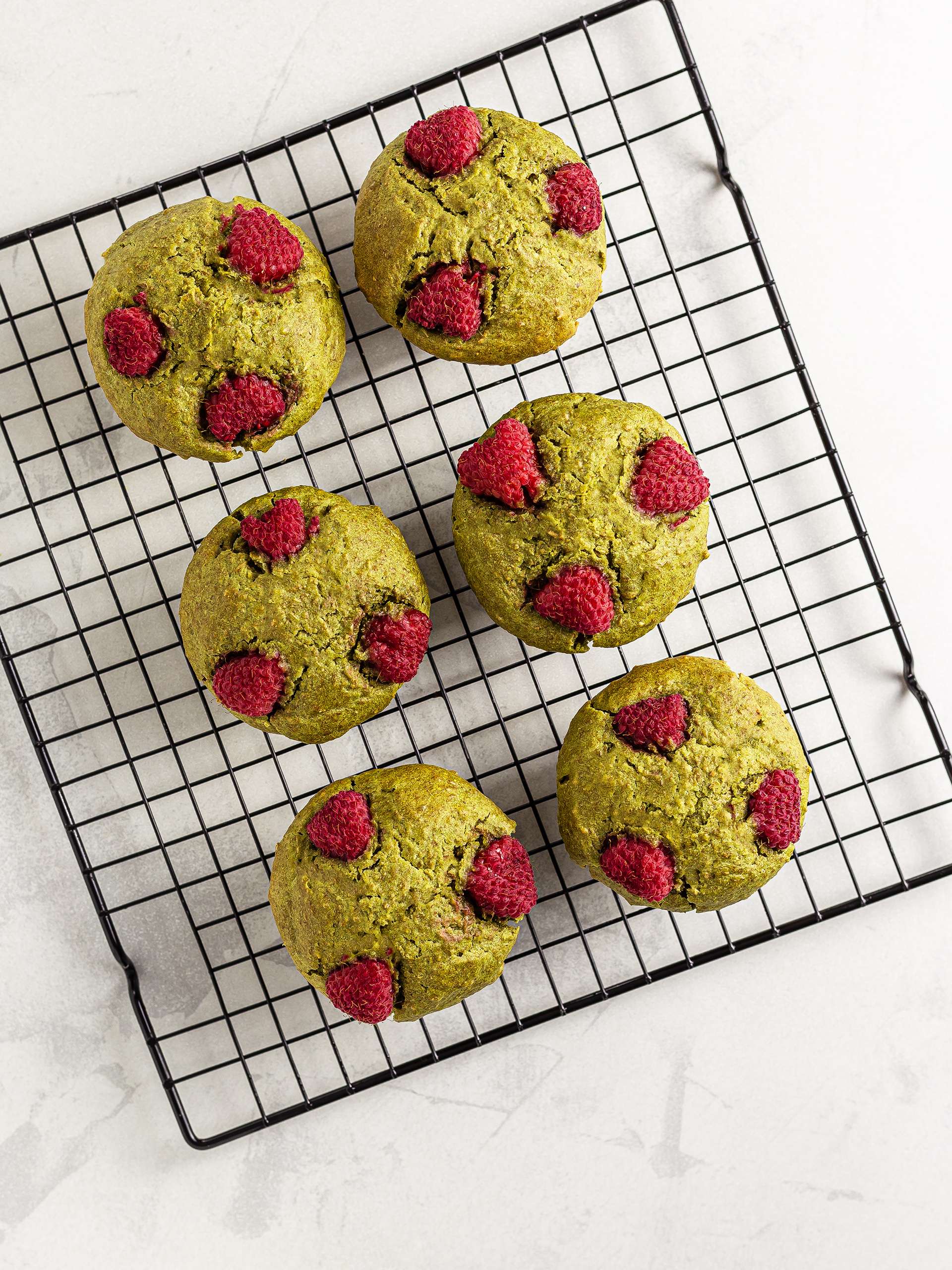 baked vegan matcha muffins on a wire rack