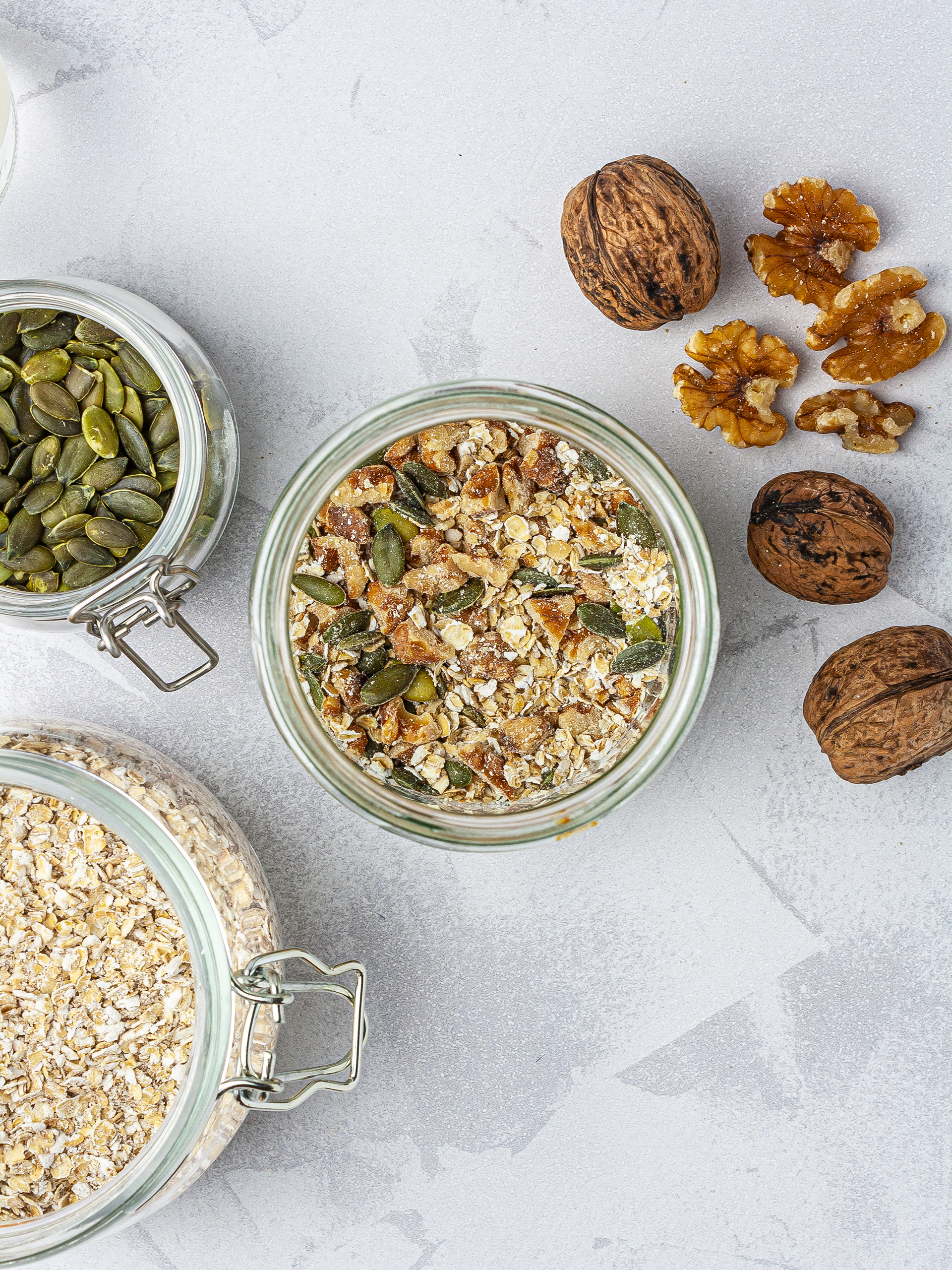 Granola layer in the smoothie jar with oats, walnut pieces, and pumpkin seeds.