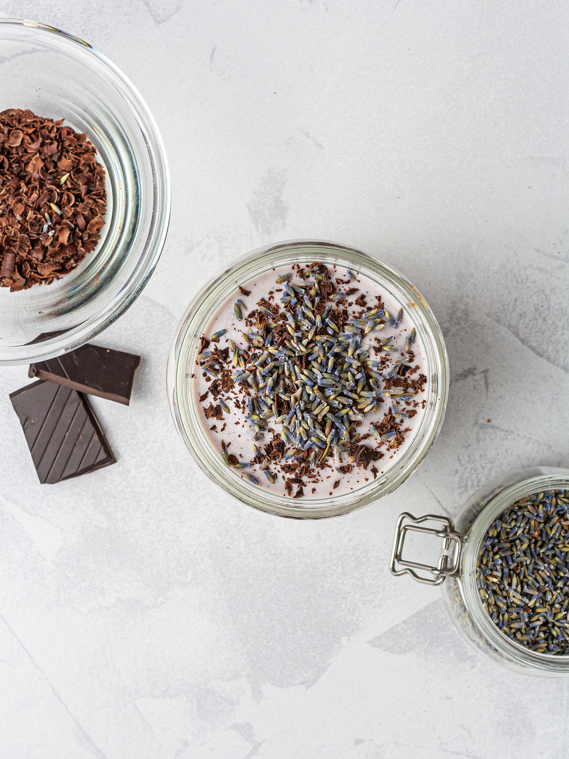 Layered lavender tea smoothie with dark chocolate shavings and lavender flowers.