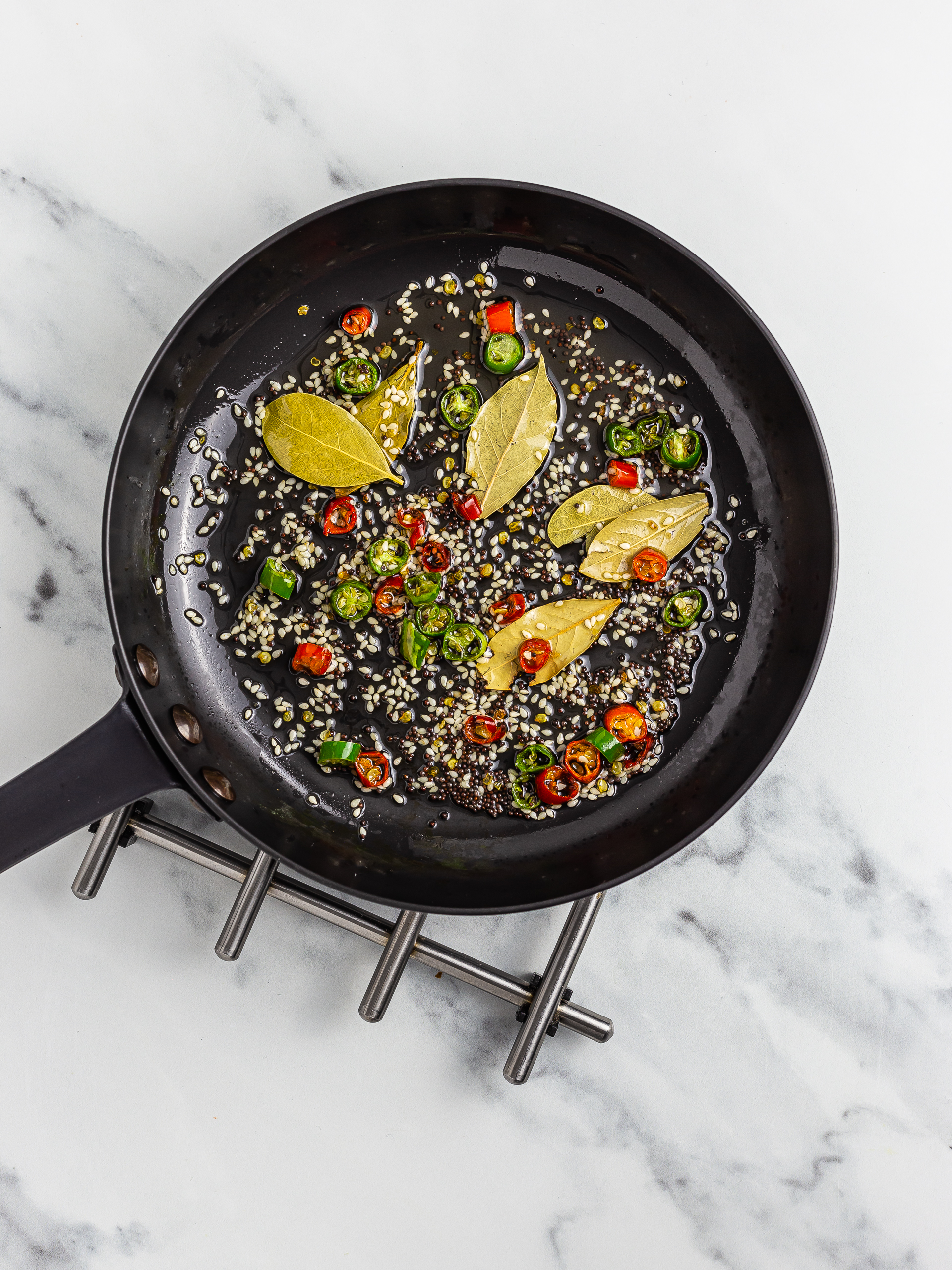 sizzle mustard and sesame seeds with curry leaves