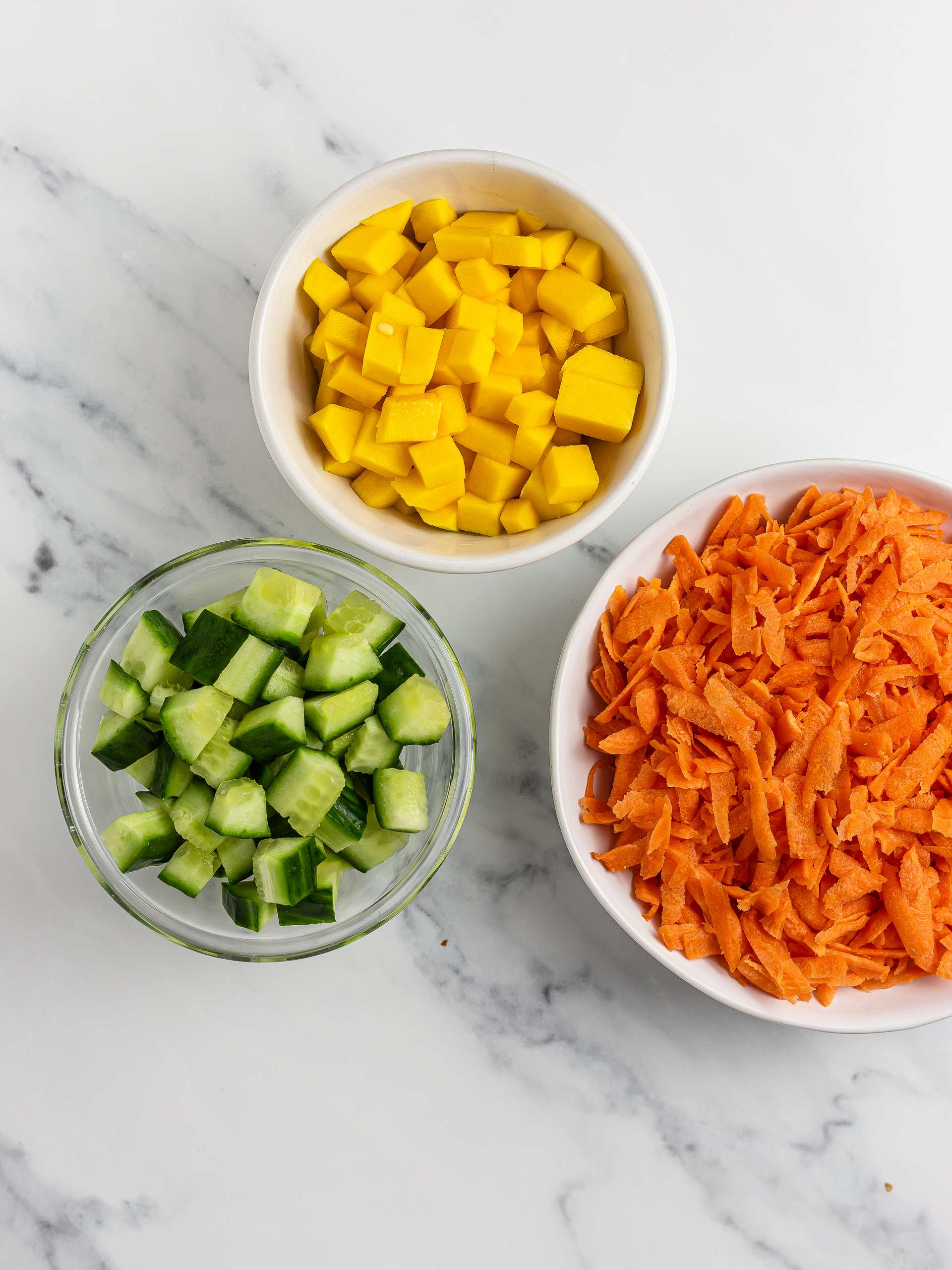 grated carrots and chopped cucumber and mango
