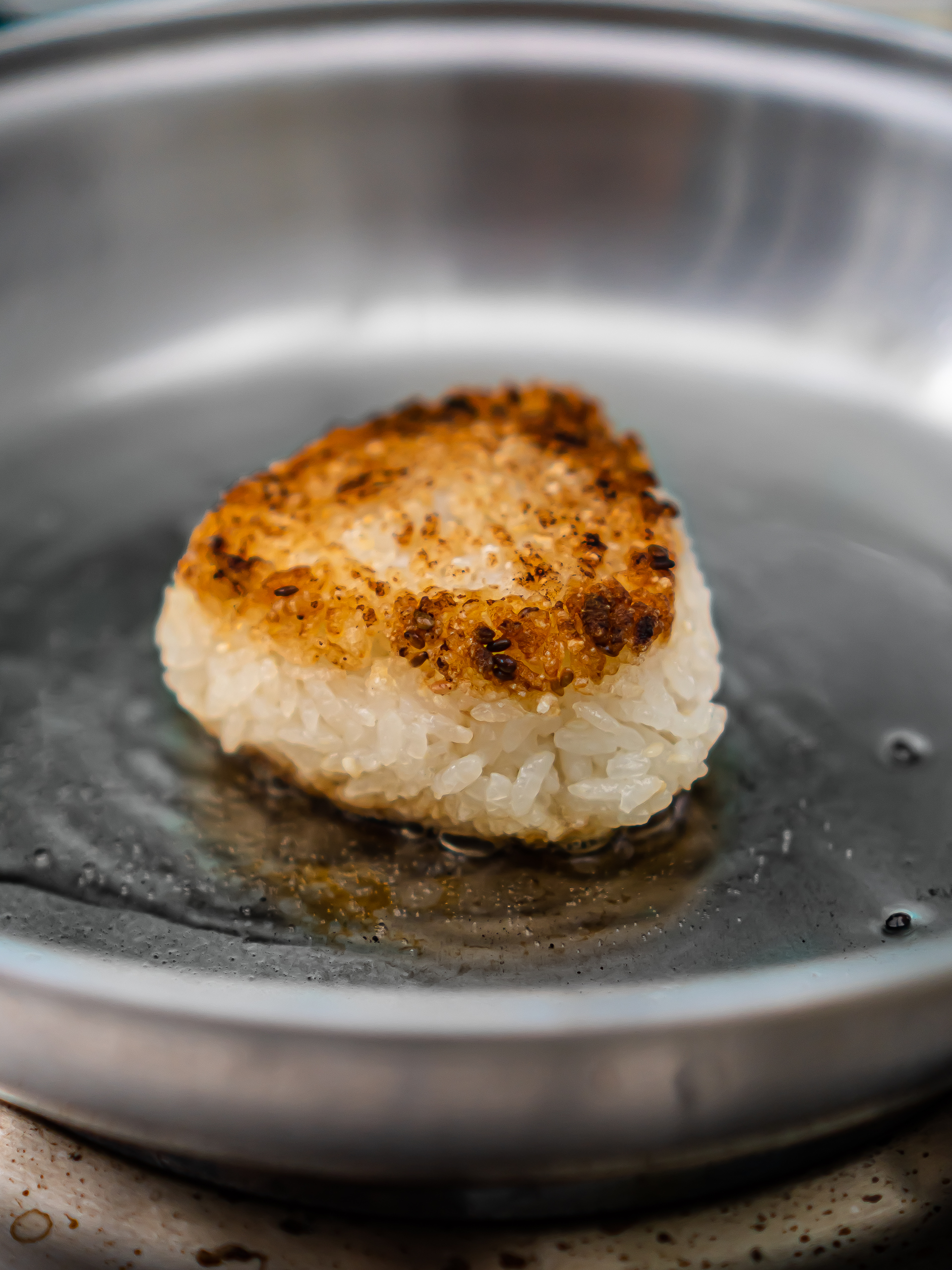 crispy yaki onigiri cooking in a pan