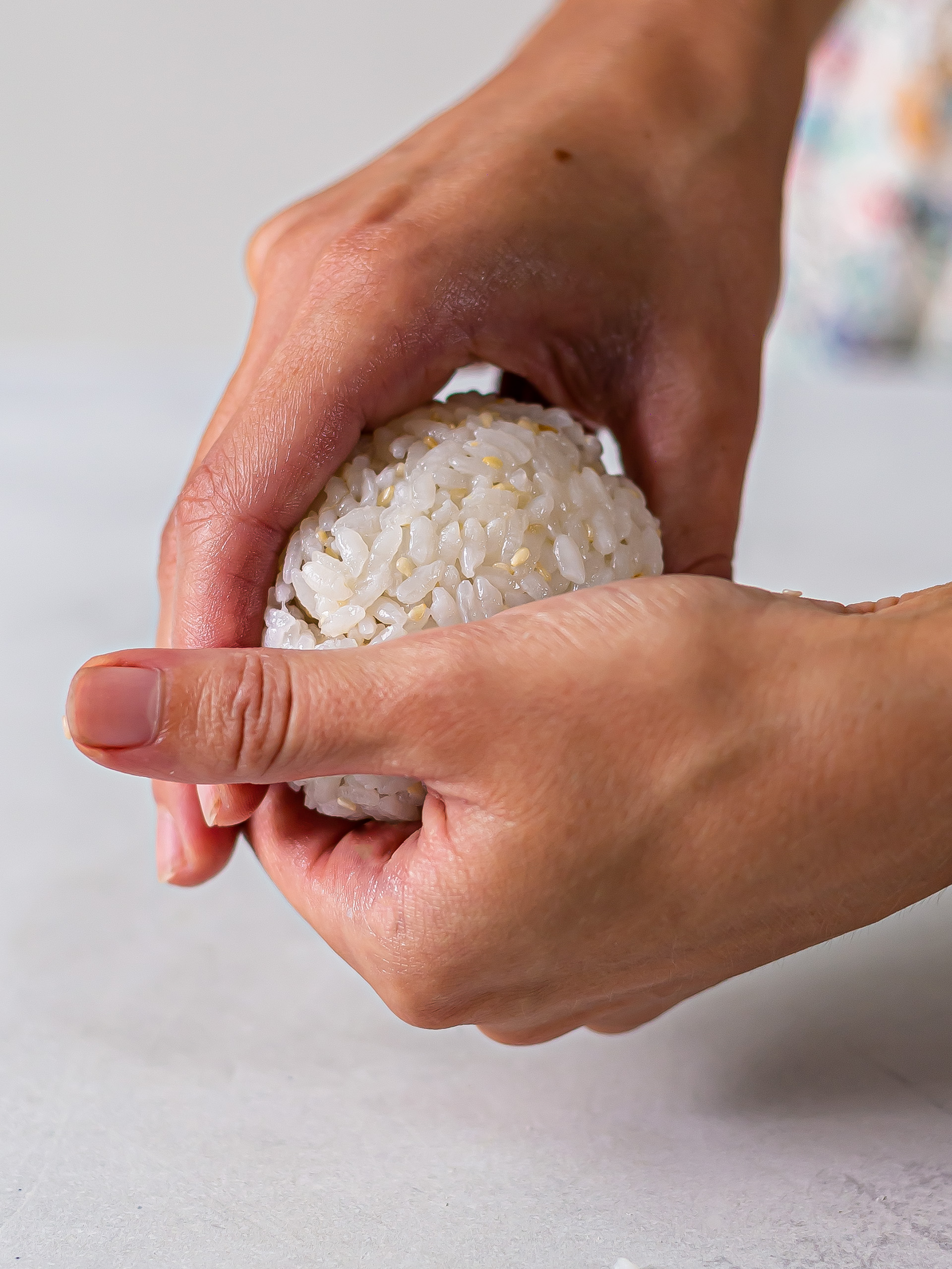 woman shaping onigiri balls