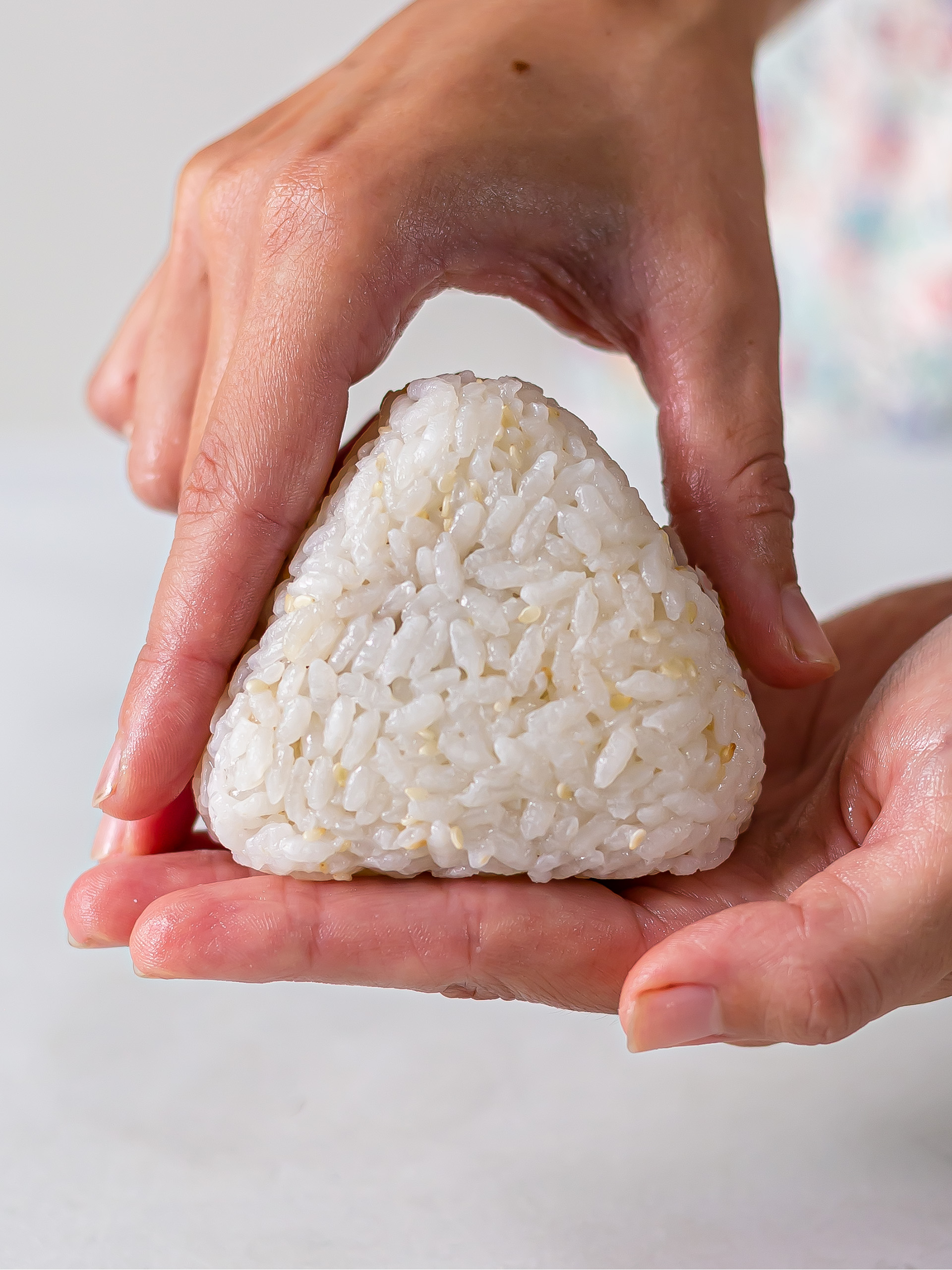 woman showing onigiri triangle 