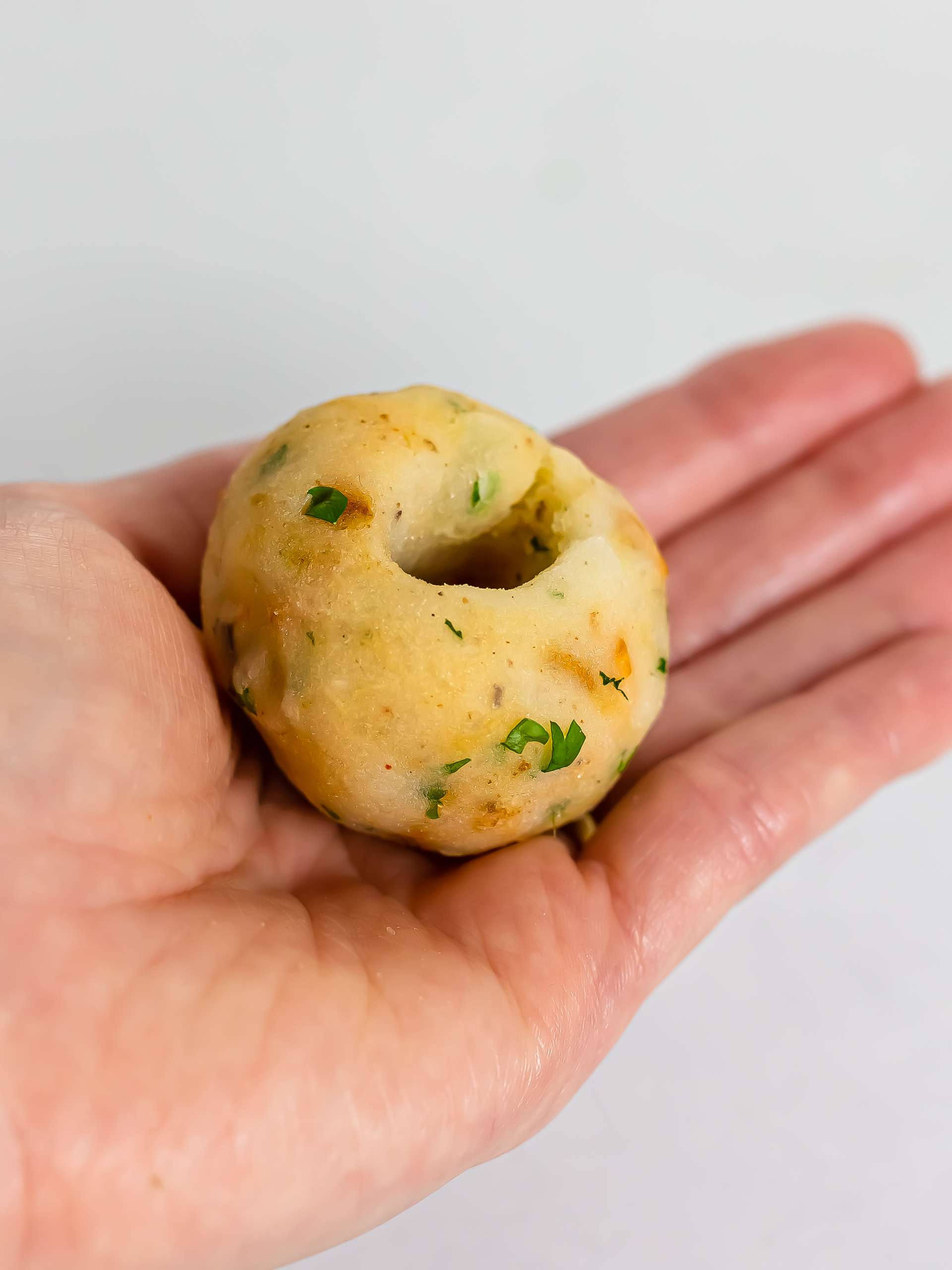 hand showing a potato croquette