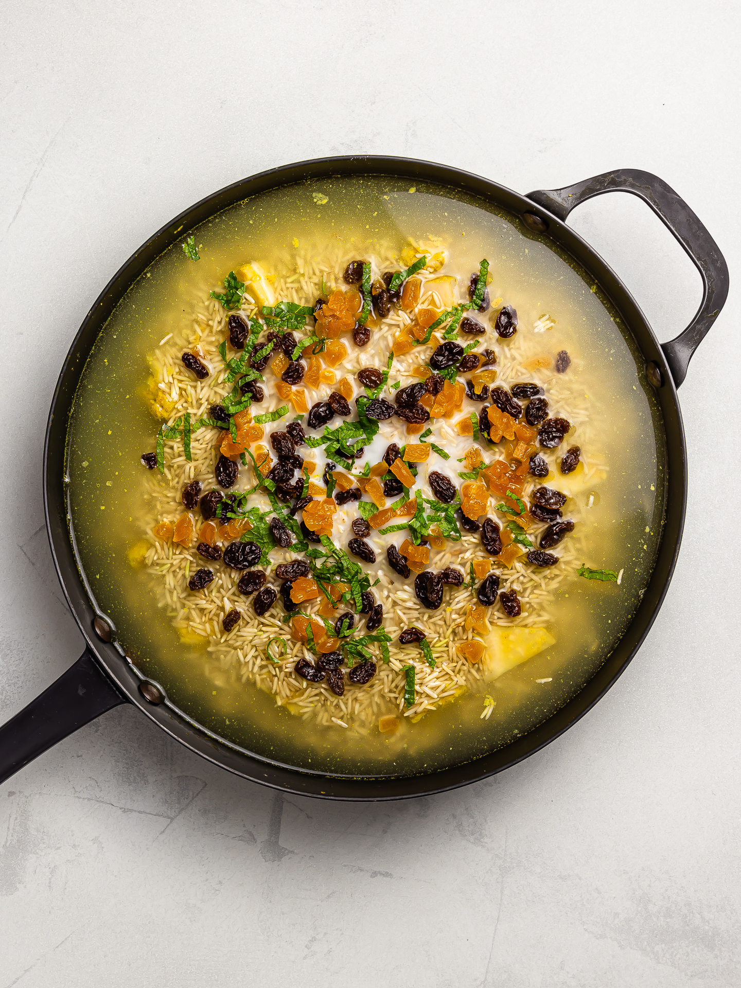 jackfruit and rice layers for biryani in a skillet