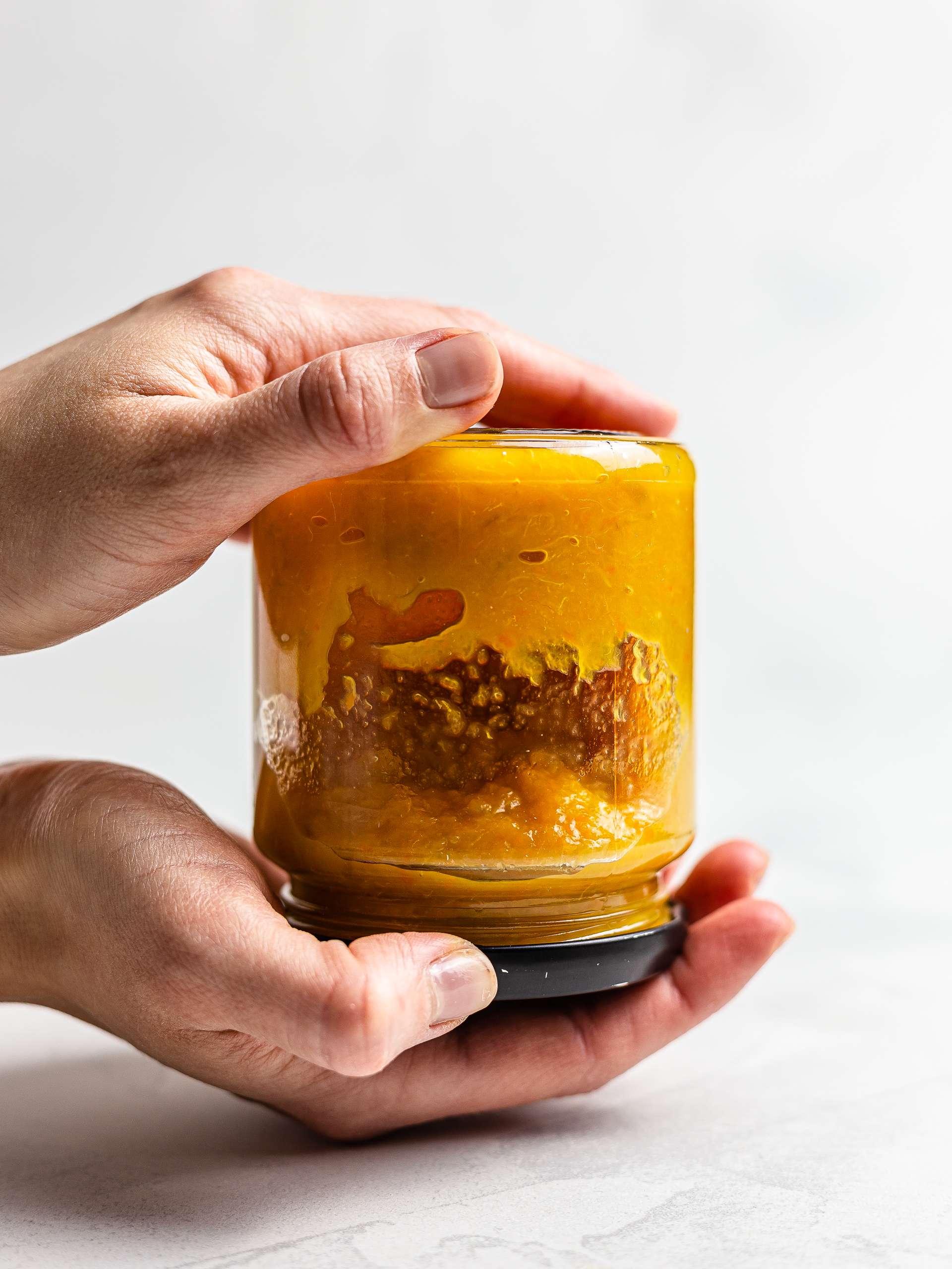 sugar-free orange jam in a jar flipped to seal it