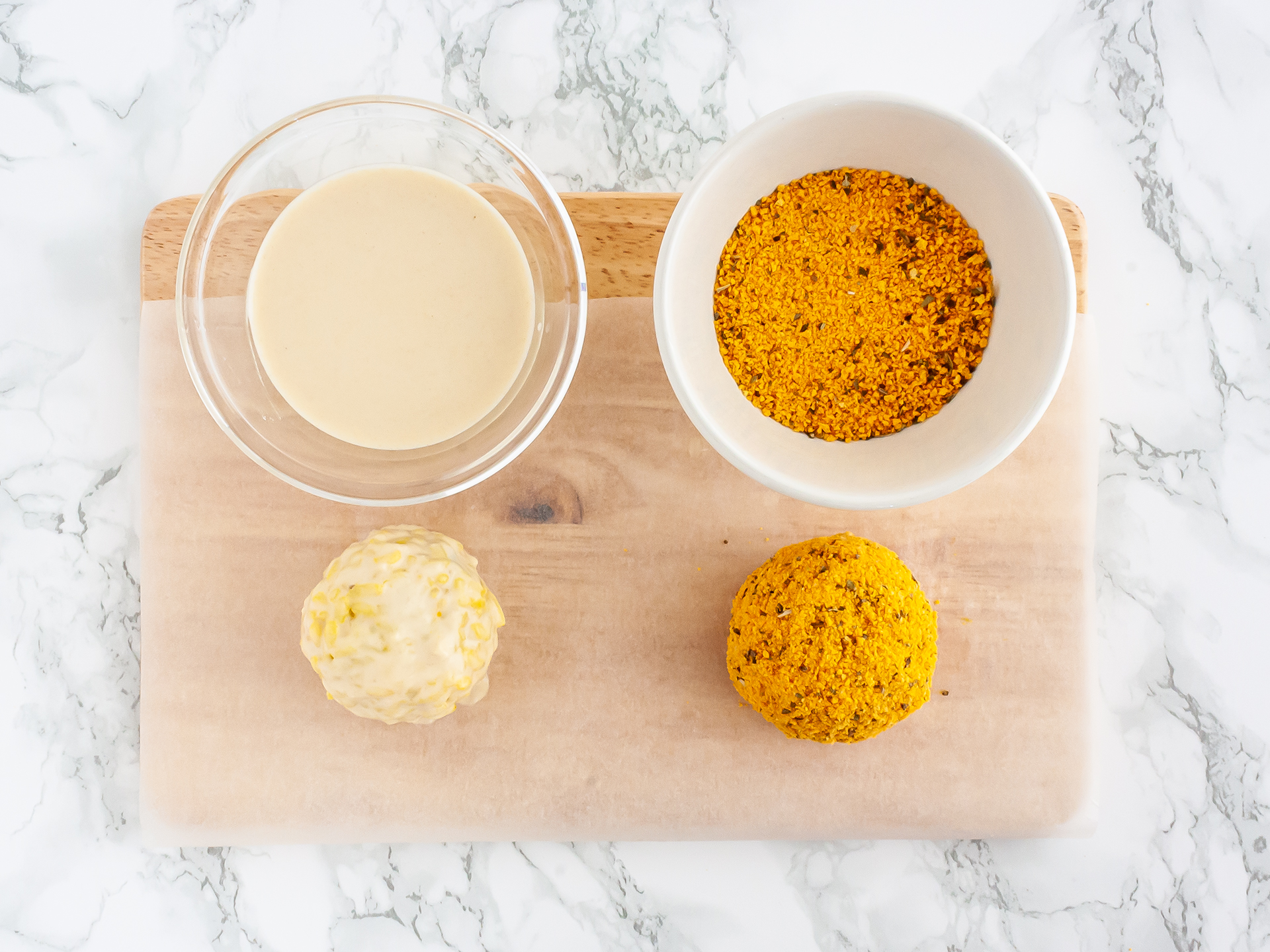 Coating the arancini with flour and breadcrumbs.