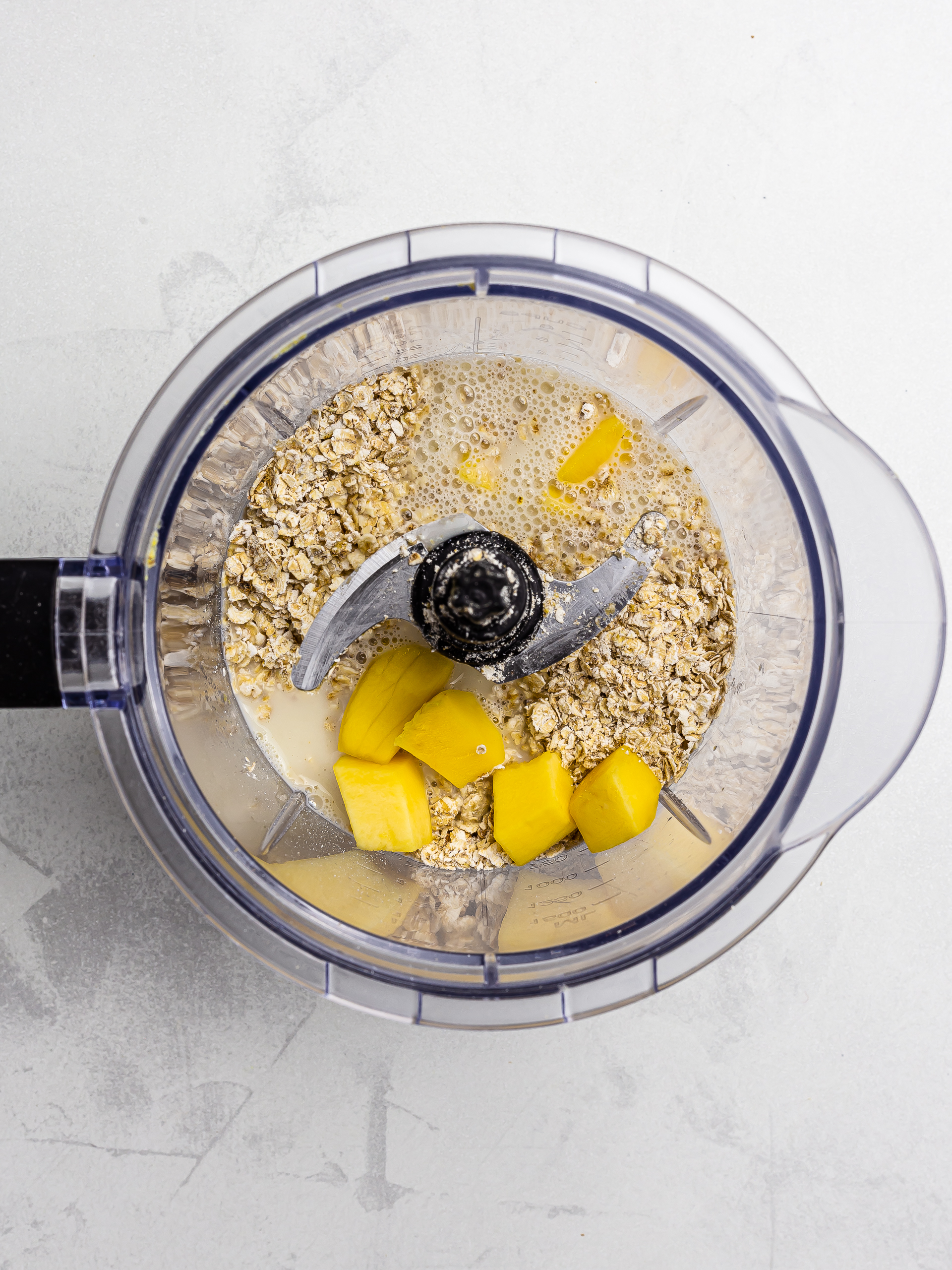 mango, oats, and oat milk in a blender