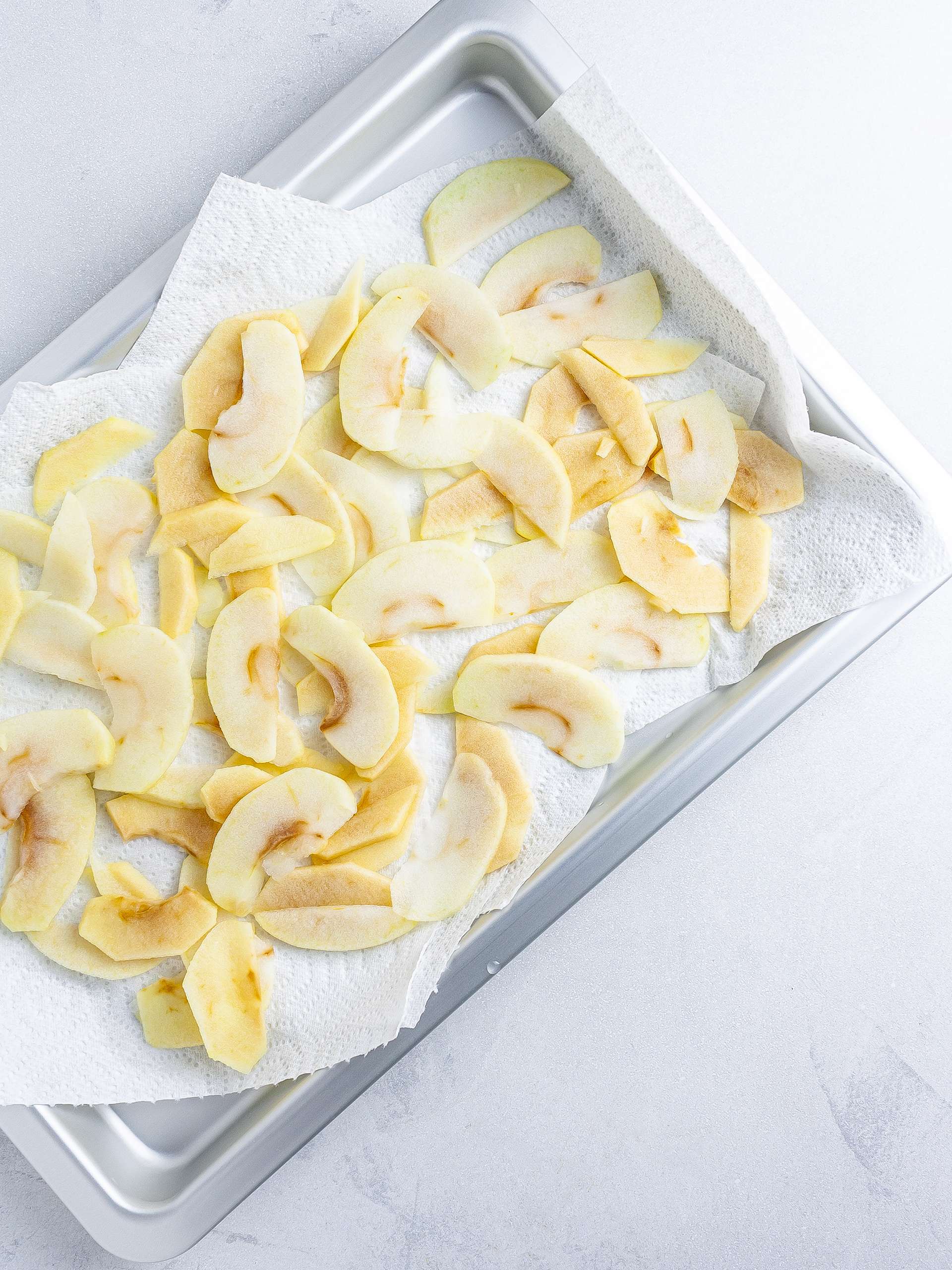 Cooked apple wedges on a tray