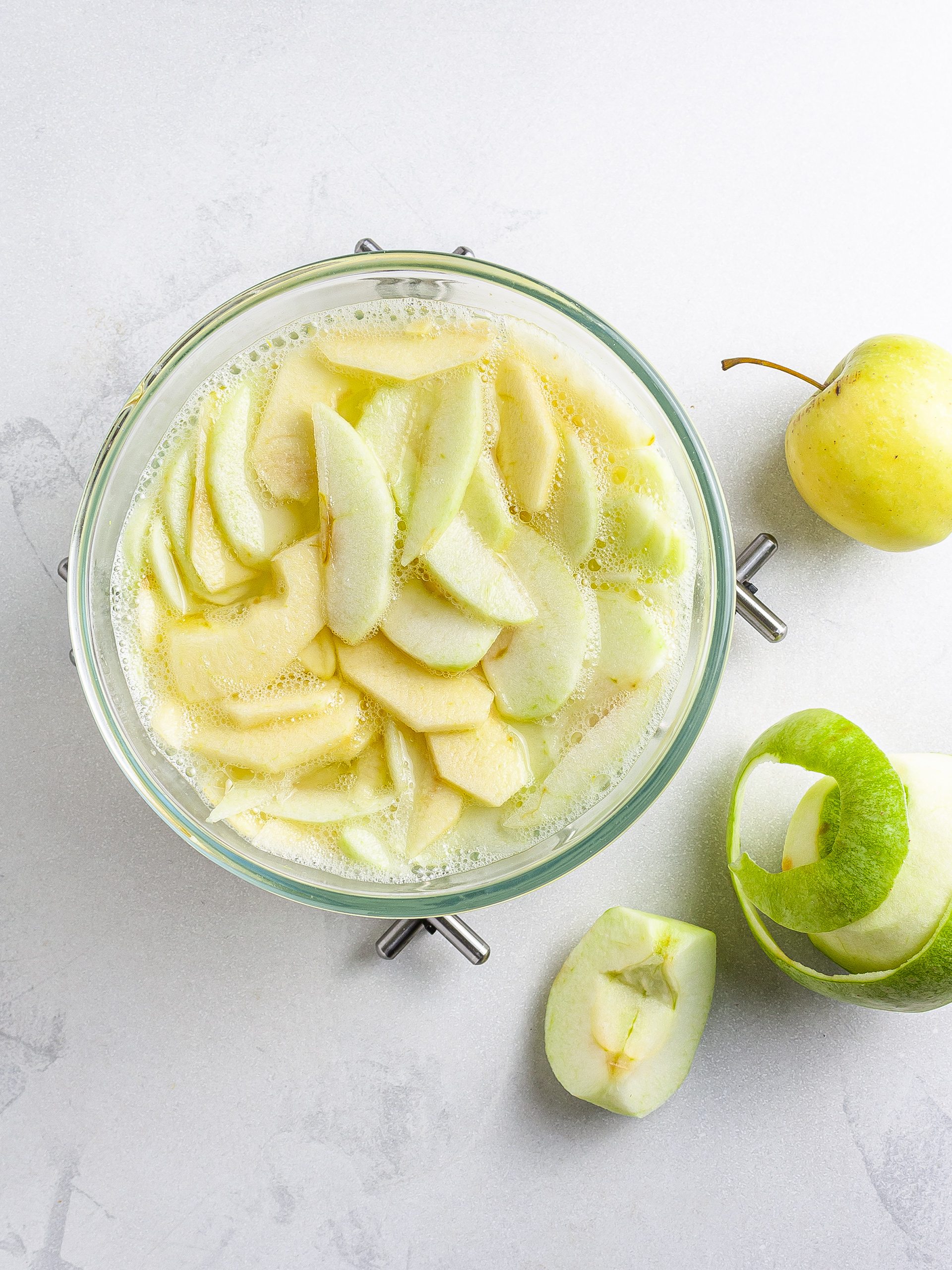 Apple wedges soaking in boiling water