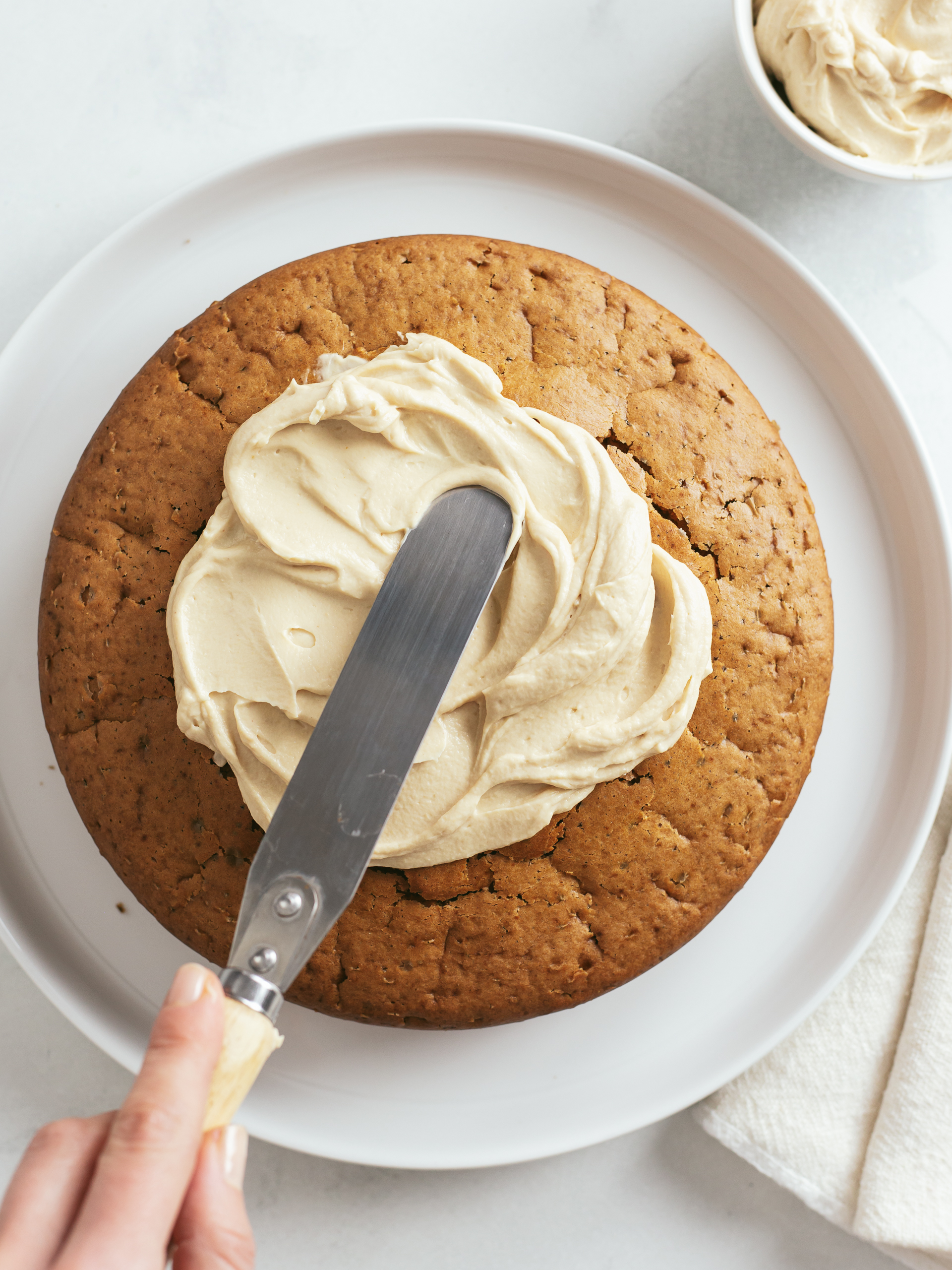 vegan masala chai cake topped with yogurt peanut butter frosting