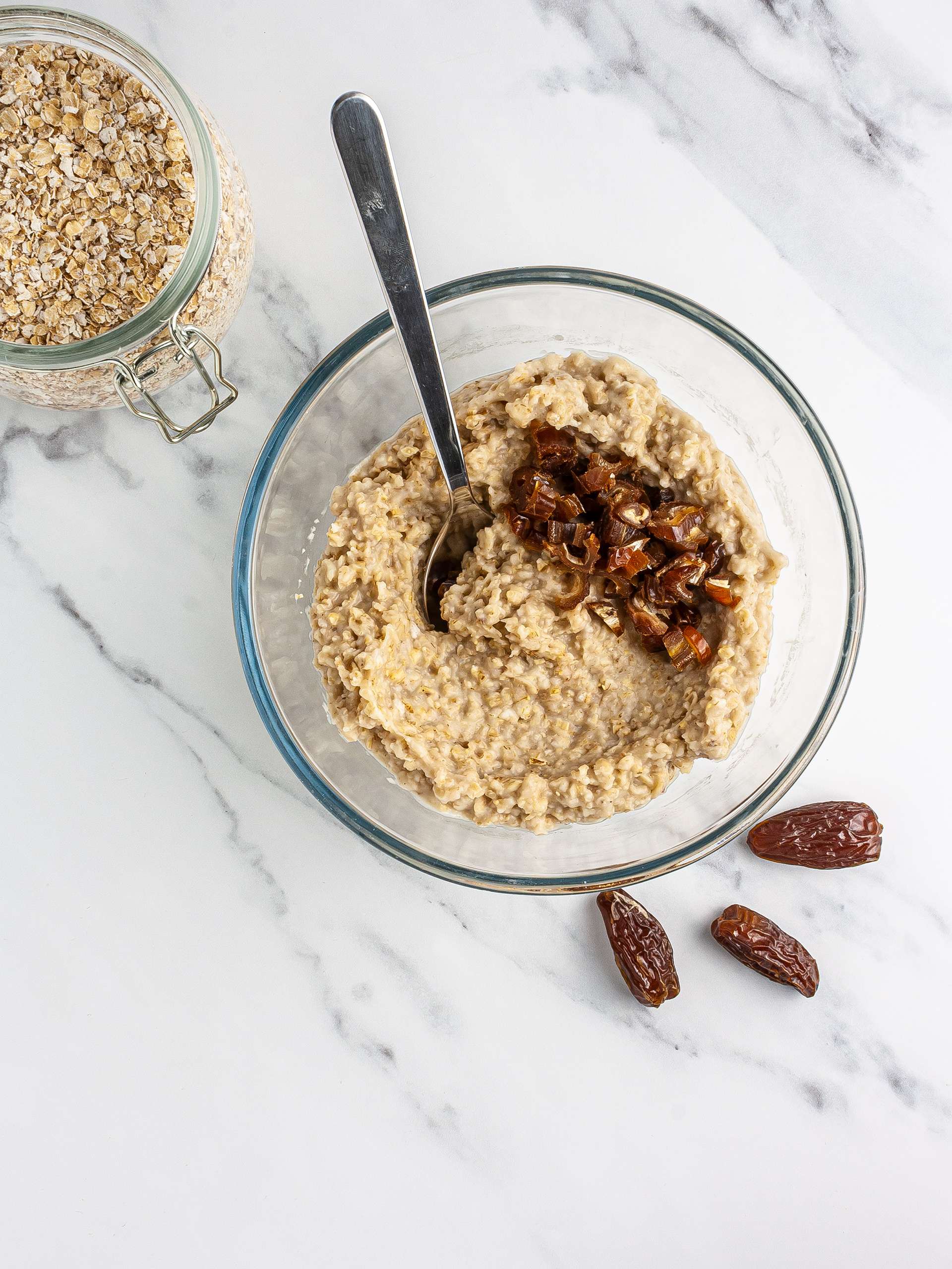 Soaked oats and chopped dates in a bowl.