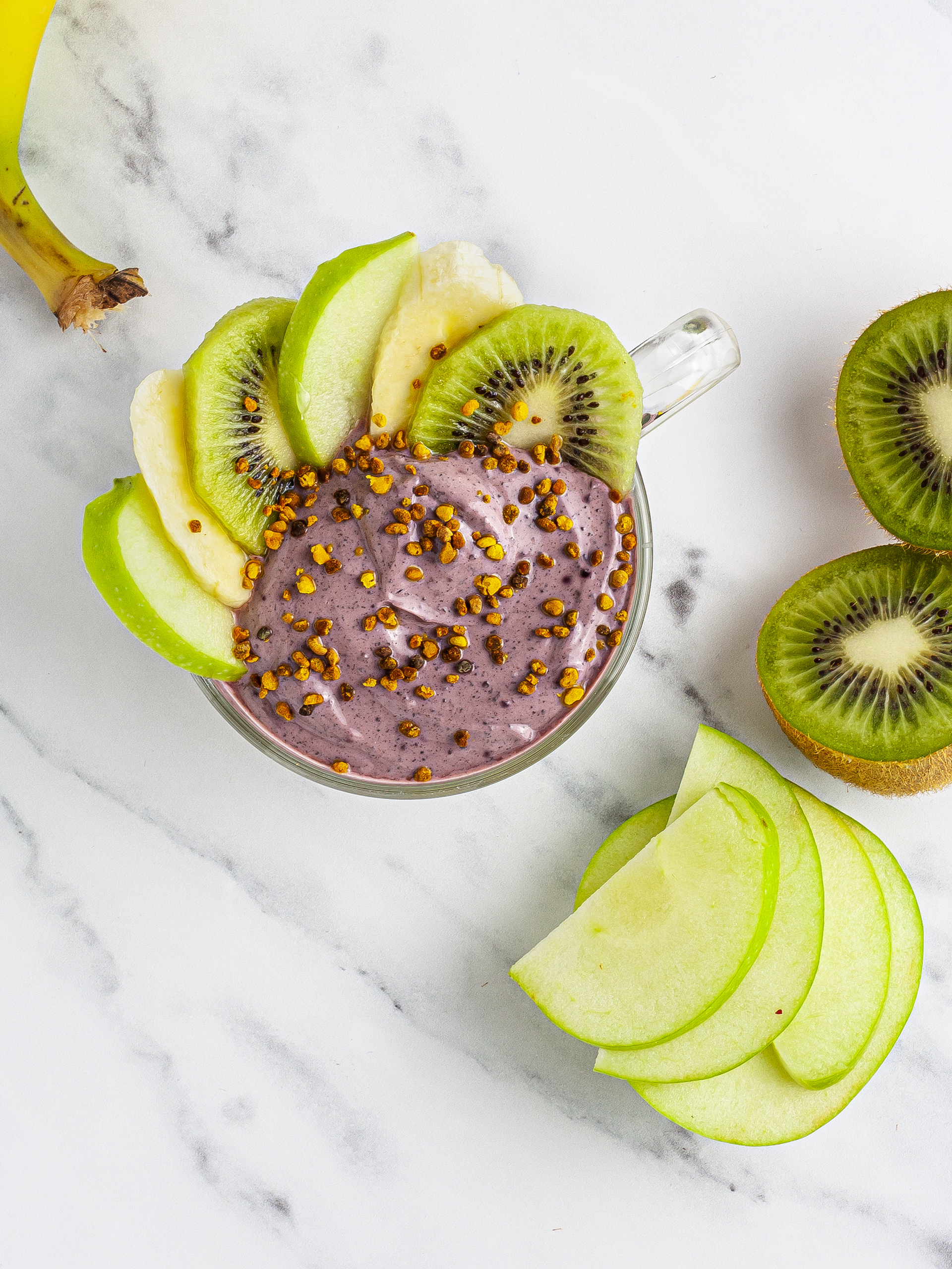 Top layer of acai yogurt and fruit garnish.