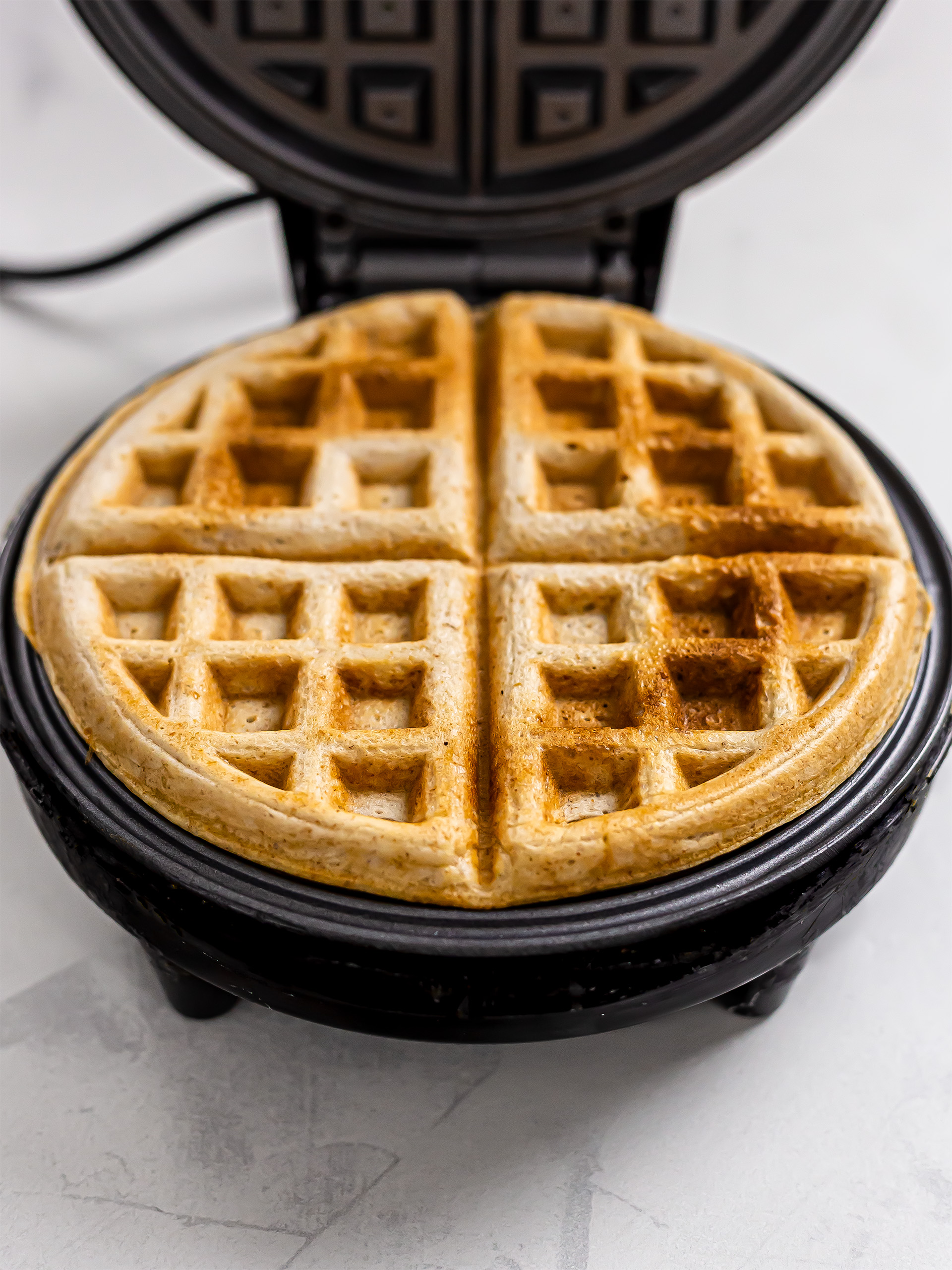 vegan sourdough waffles in a waffle machine