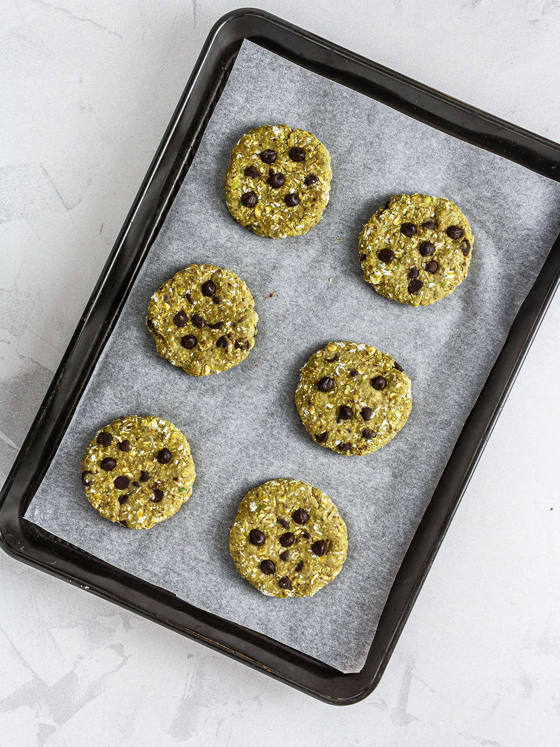 Shaped matcha chocolate chip cookies on a tray