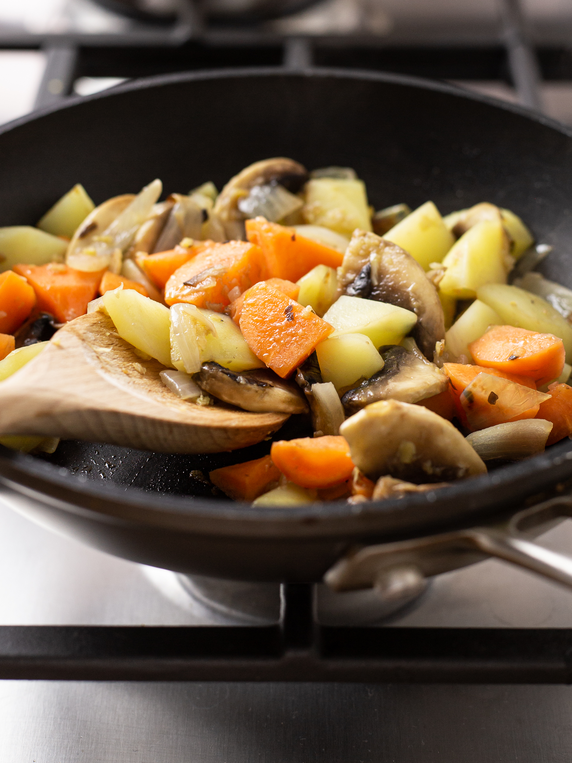 cooked potatoes, mushrooms, and carrots in a pan