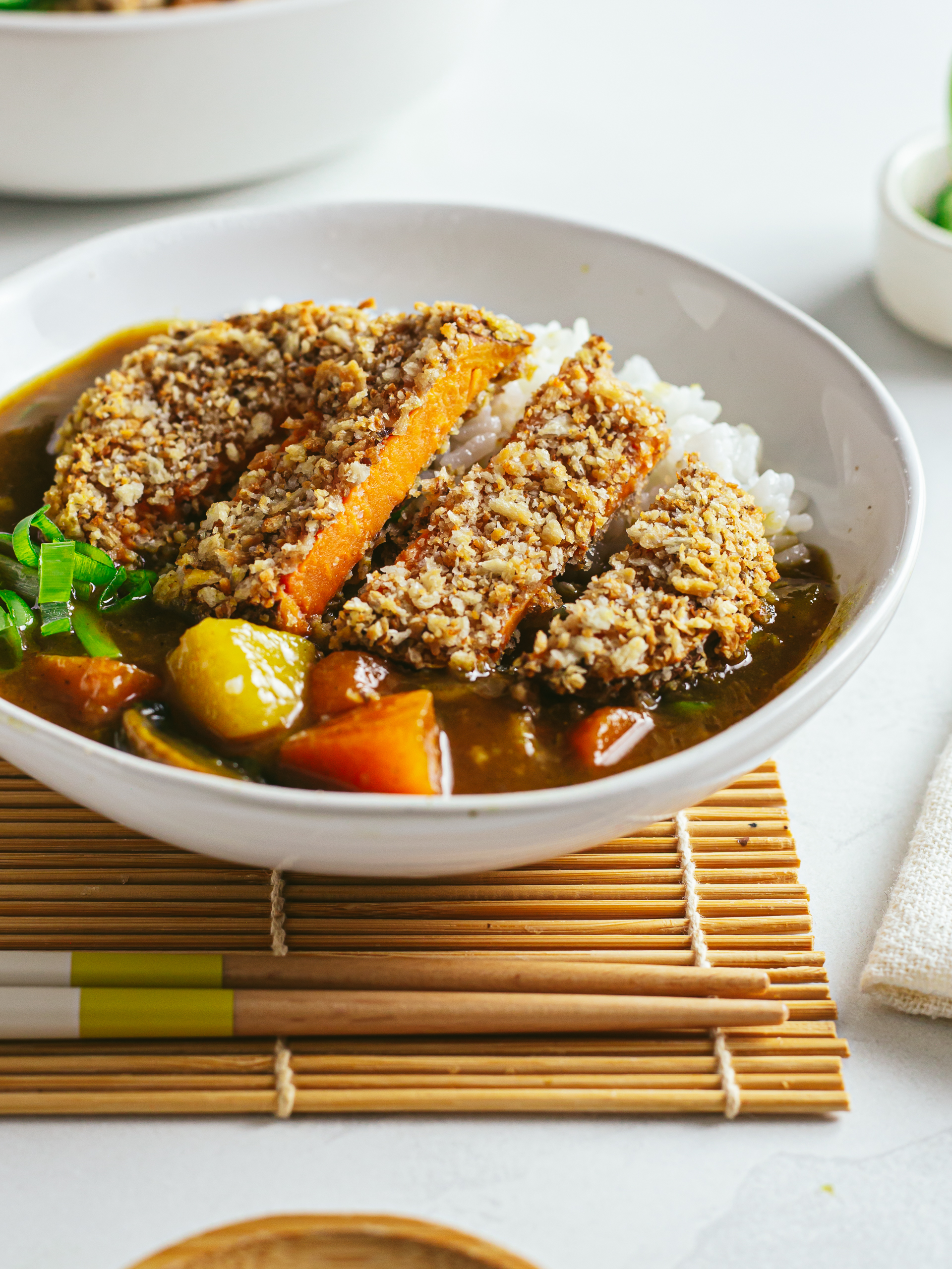 baked sweet potato katsu curry with rice in a bowl
