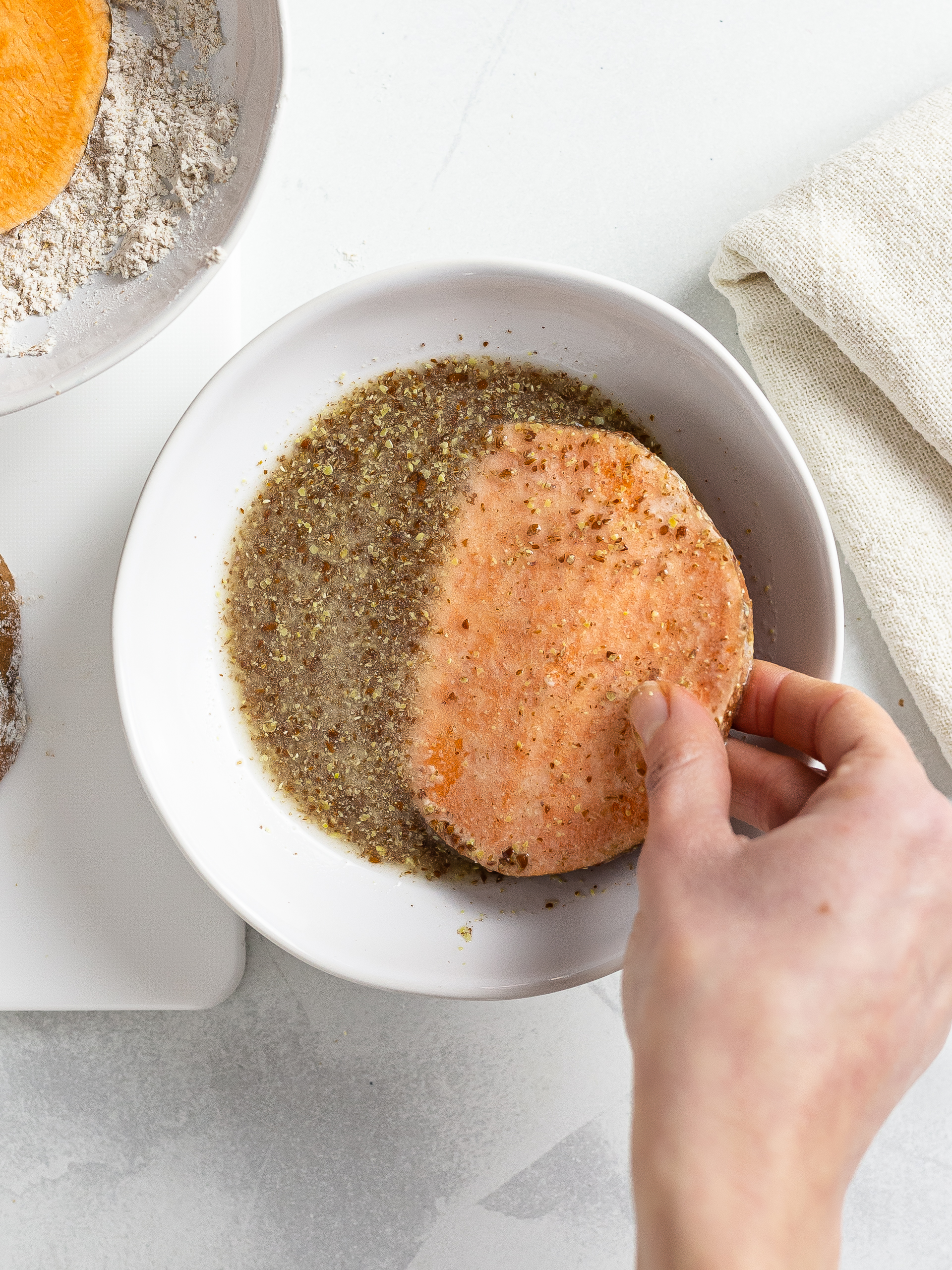 sliced sweet potatoes coated with flaxseed egg