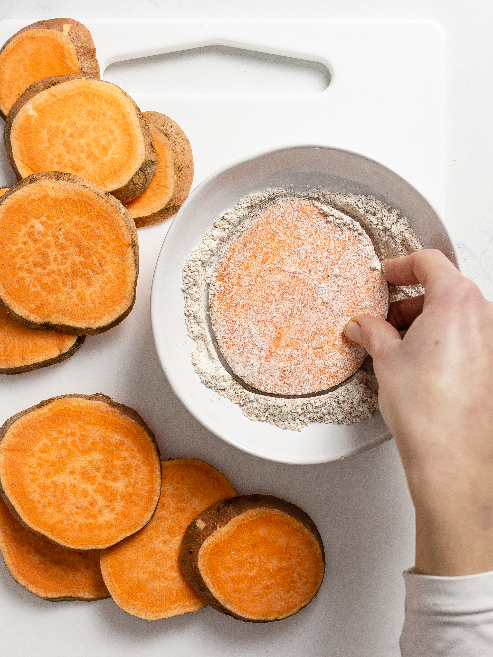 sliced sweet potatoes coated with flour