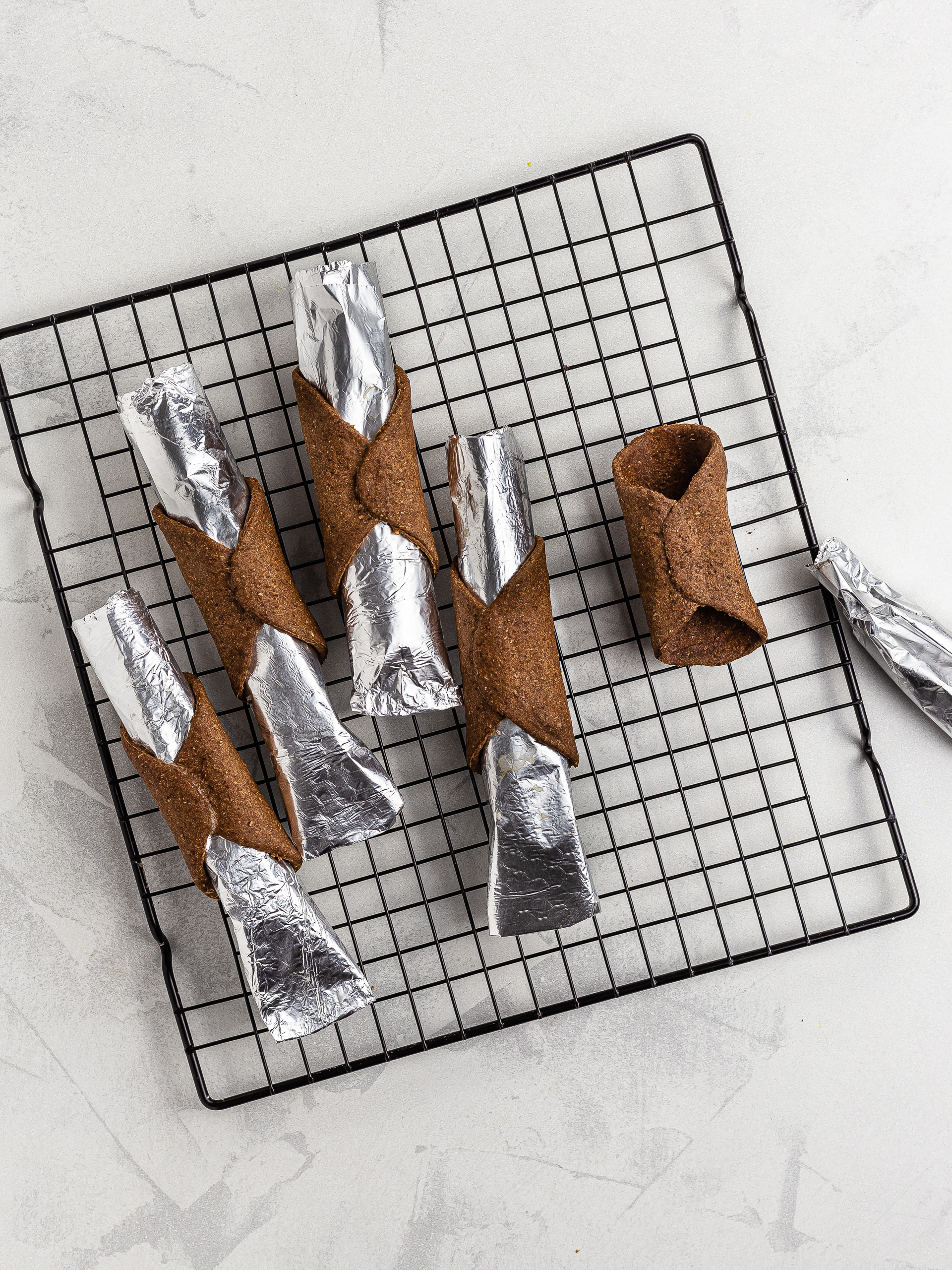 oven-baked vegan cannoli shells cooling on a wire rack