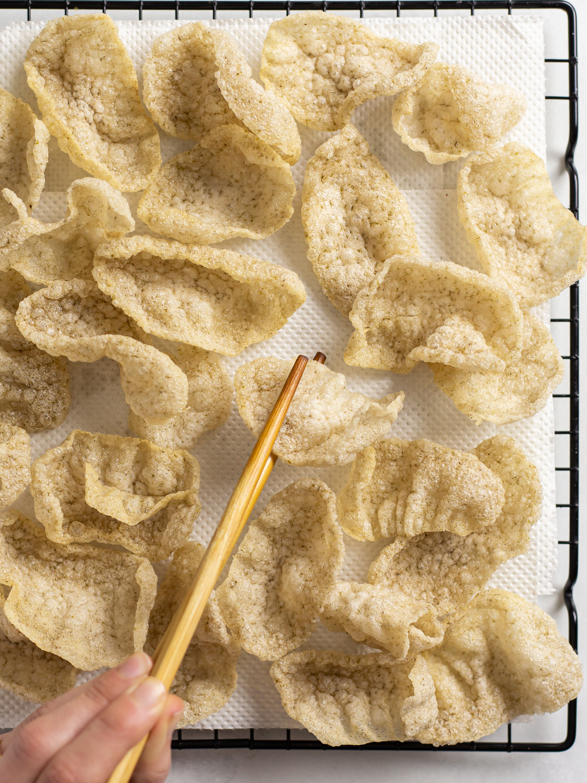 fried vegan prawn crackers on a rack lined with paper