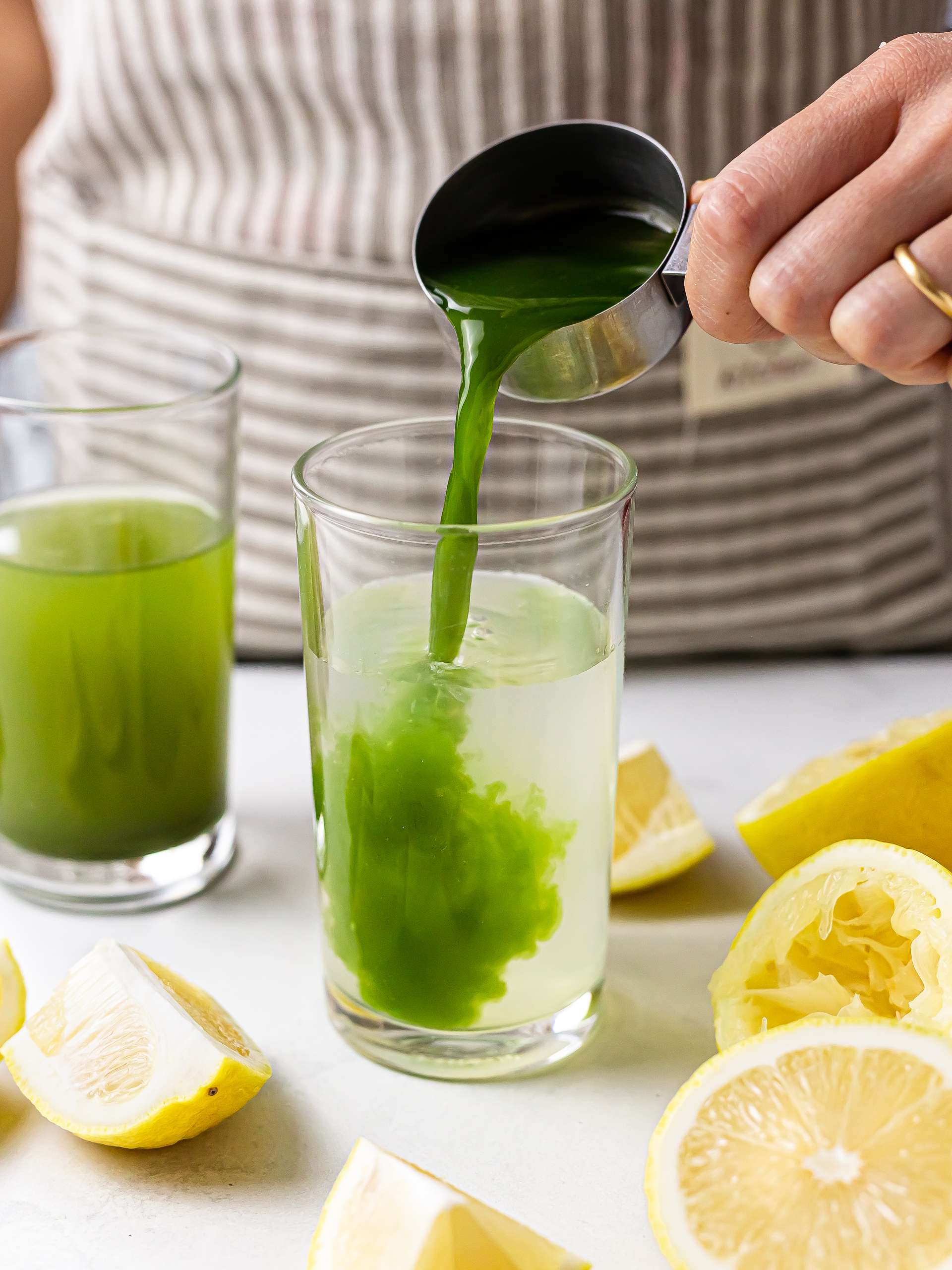 matcha green tea poured into lemonade in a glass