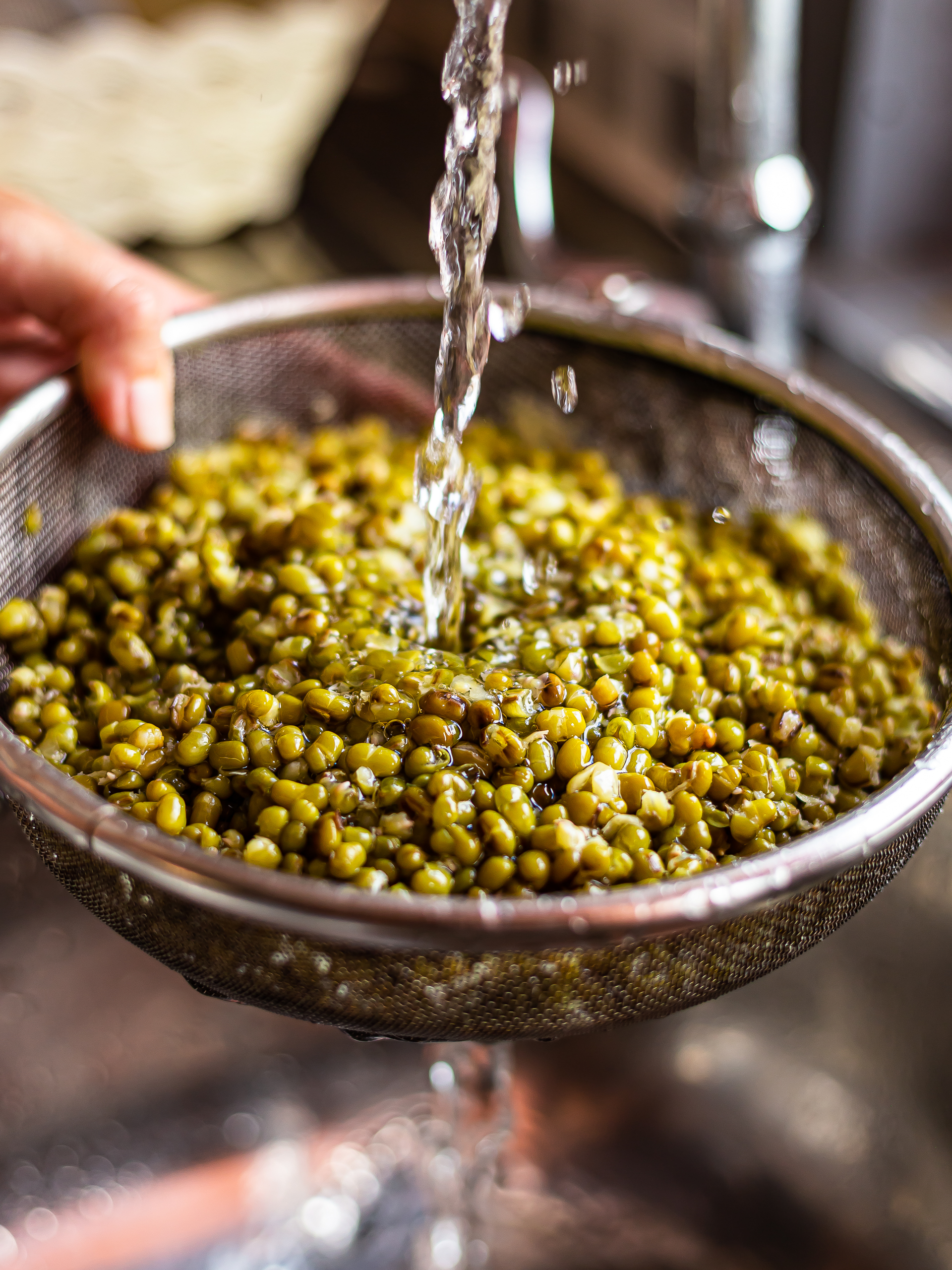 woman rinsing mung beans