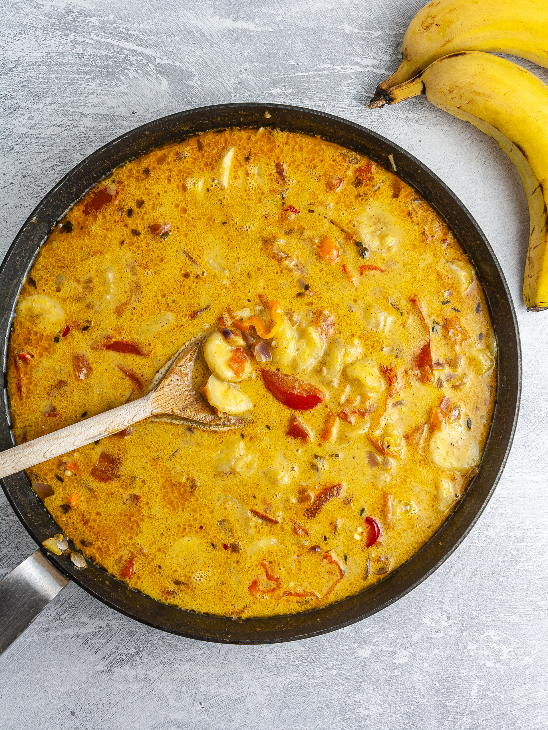 Sliced bananas added to the coconut curry