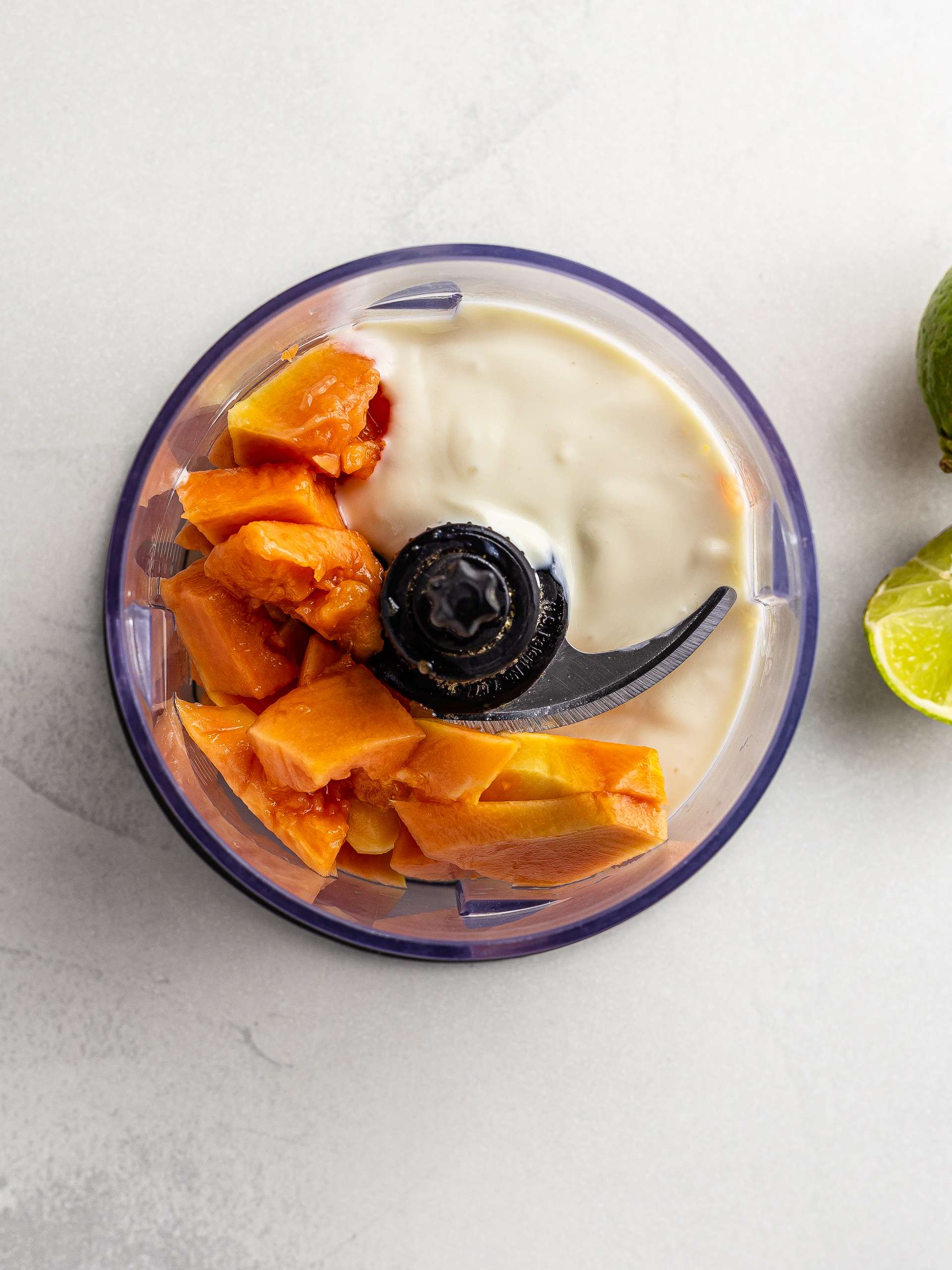 papaya yogurt and lime juice in a blender
