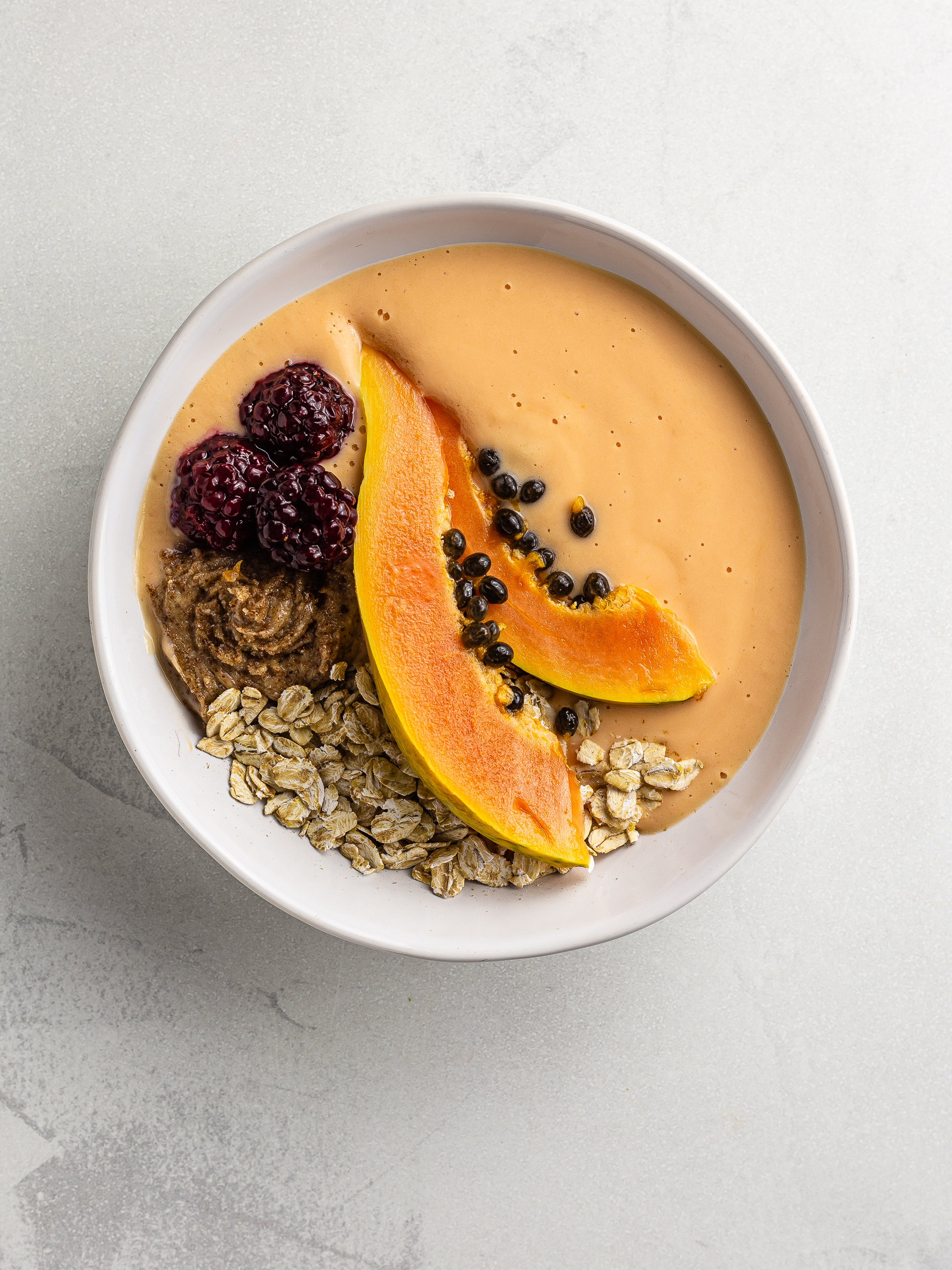 papaya smoothie bowl with oats and blackberries