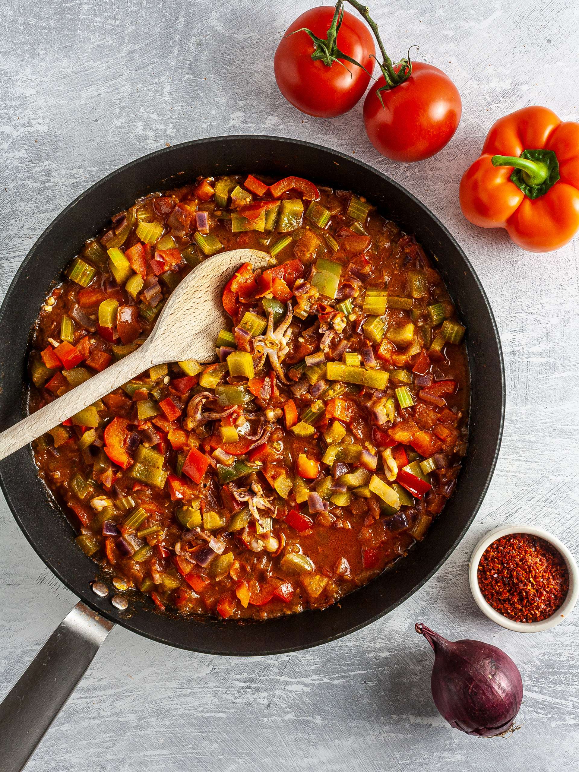 Cooked tomatoes, pepper, onions, and celery in a skillet