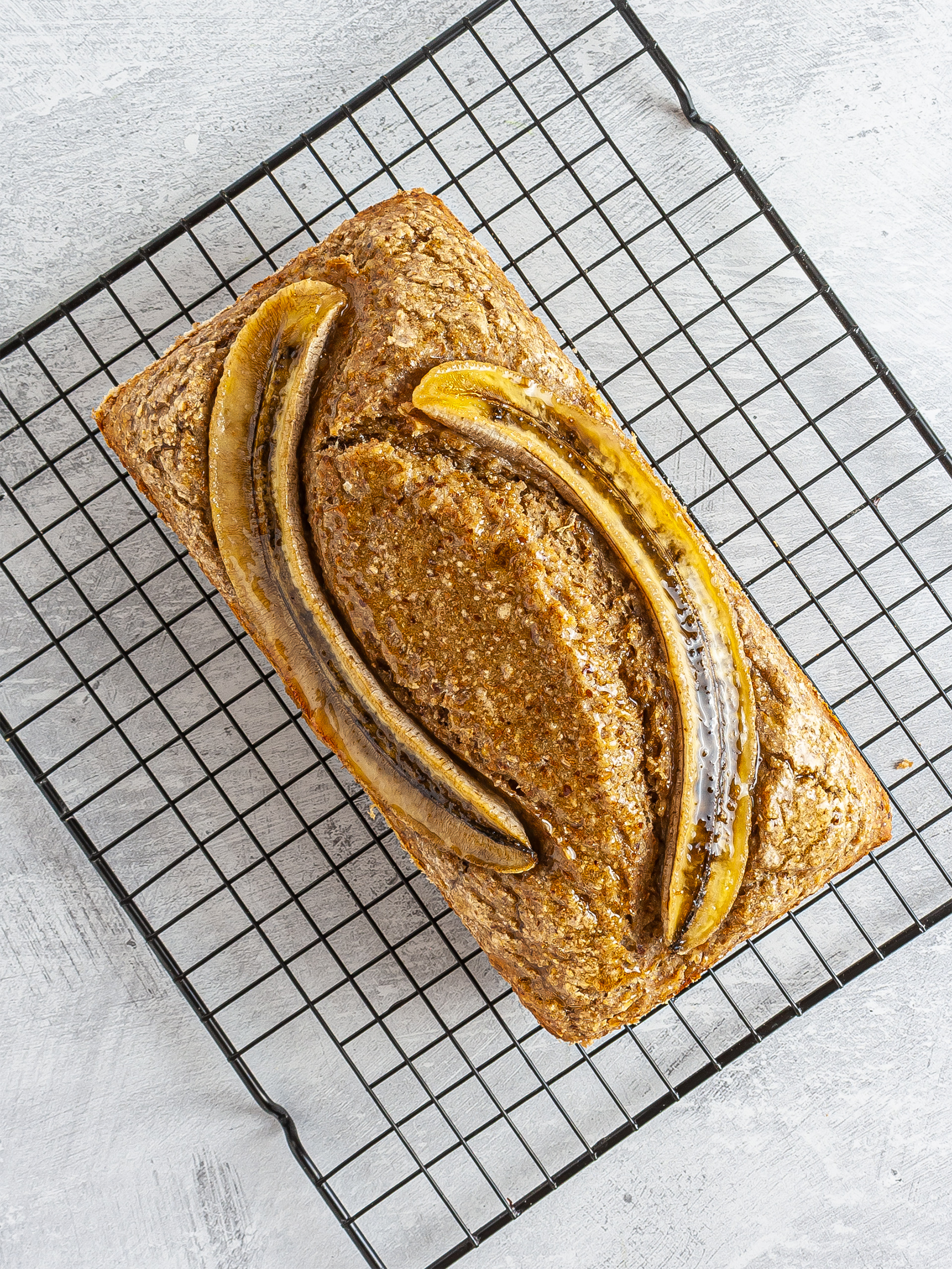 Baked banana bread on a cooling rack