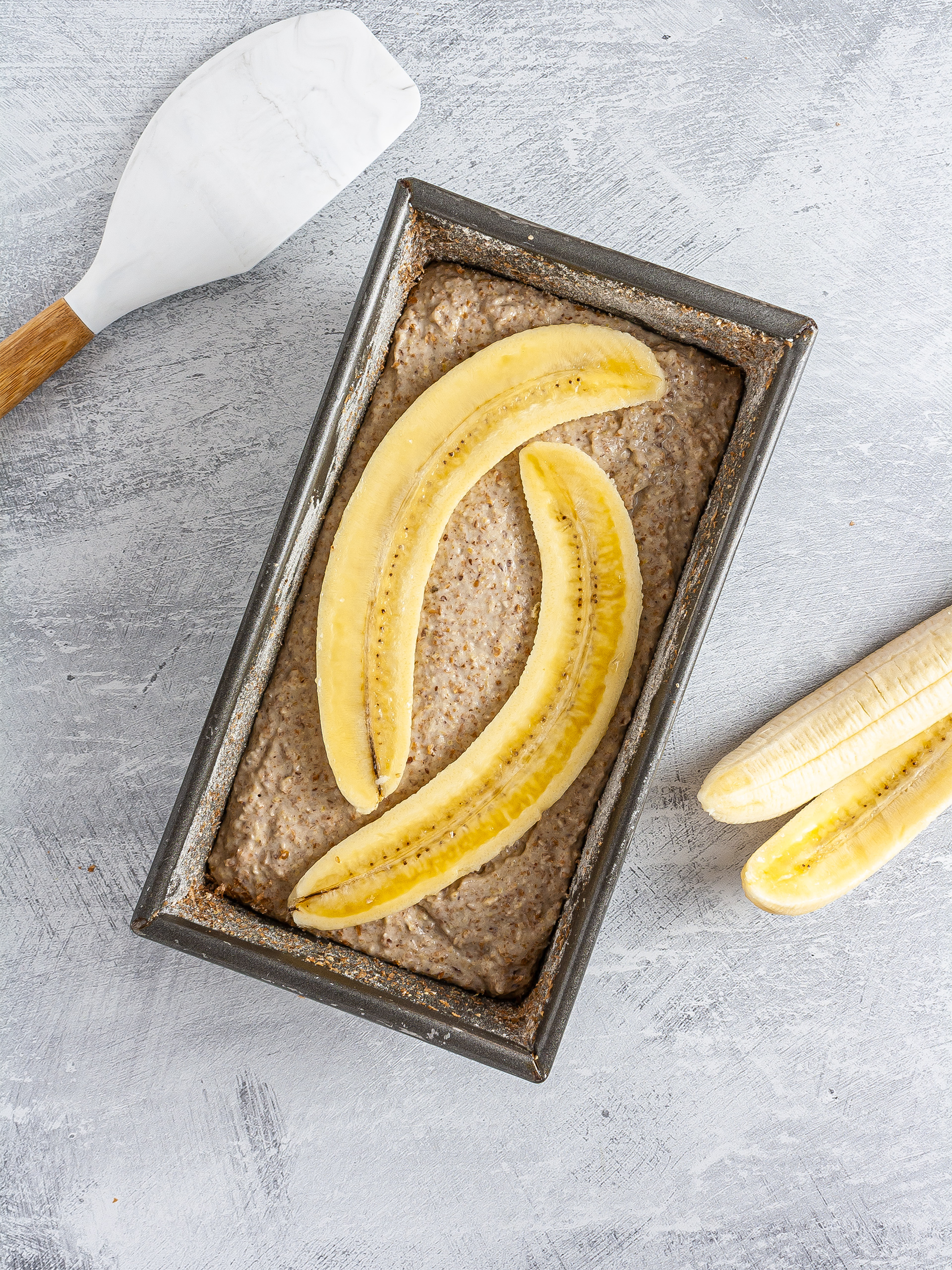 Banana bread batter in loaf tin