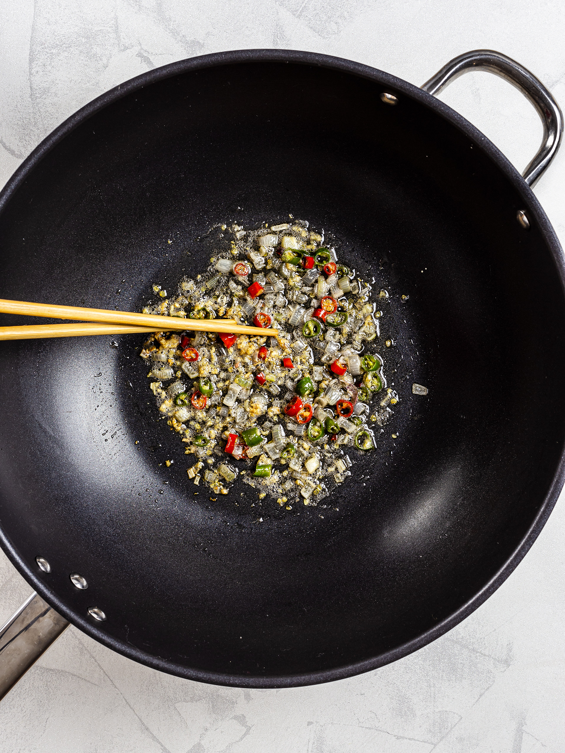 Onion and chillies stir fry in a wok