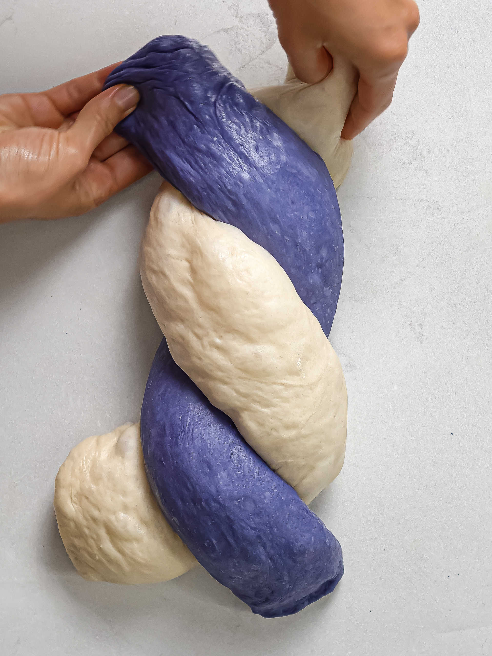 braided white and blue bread dough