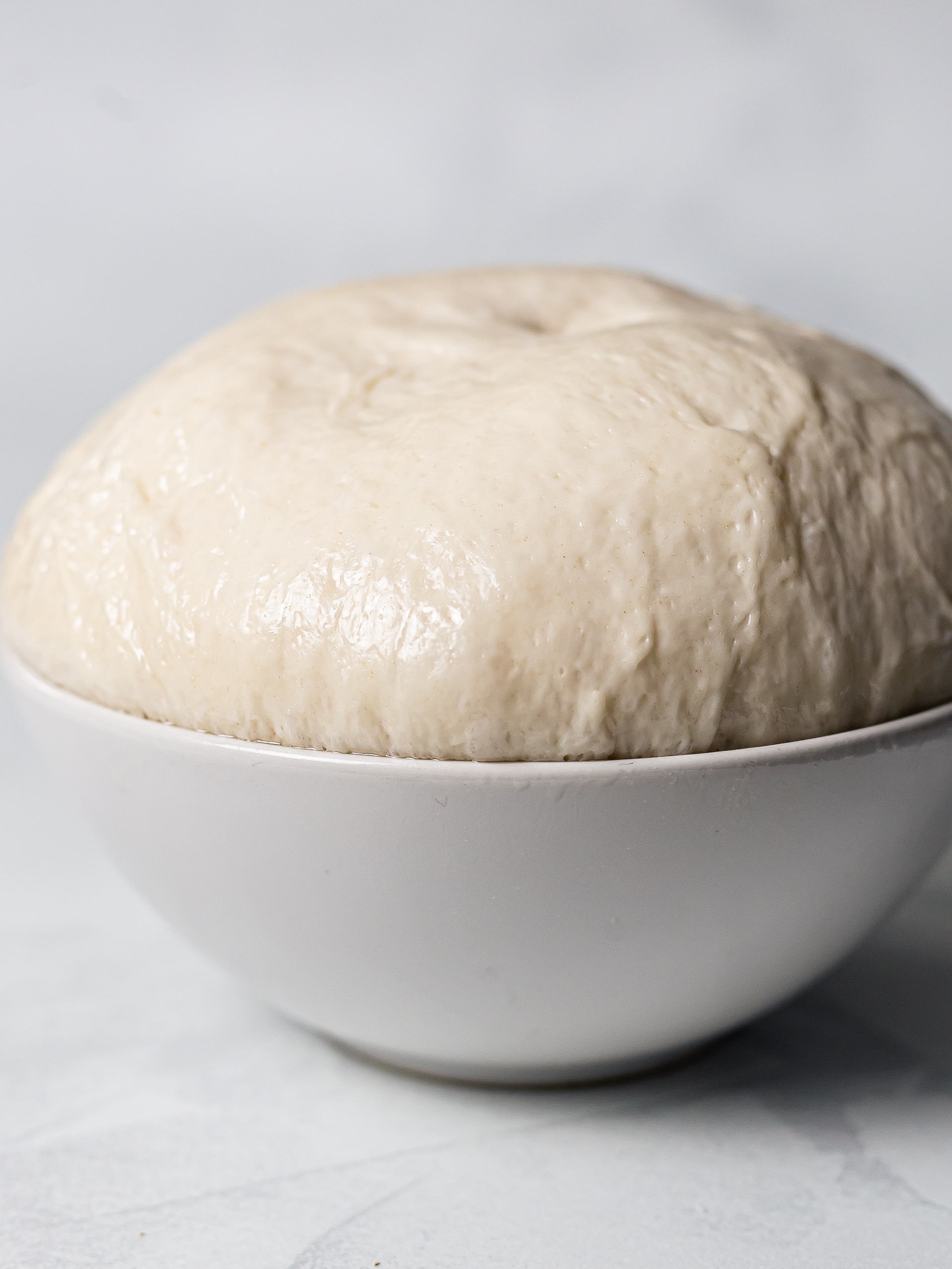 proved milk bread dough in a bowl