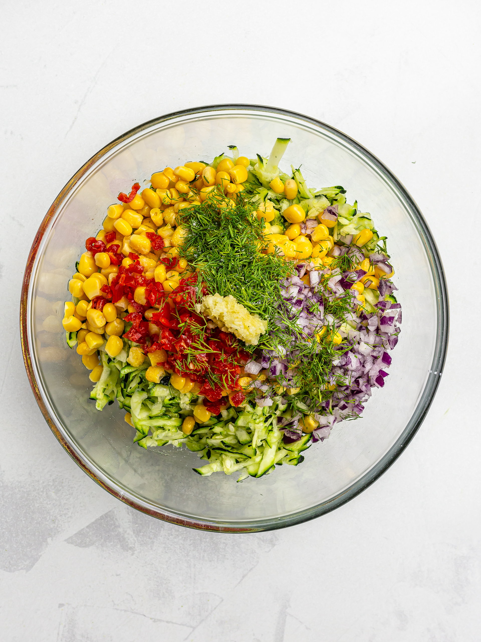 courgette and corn fritters ingredients in a bowl