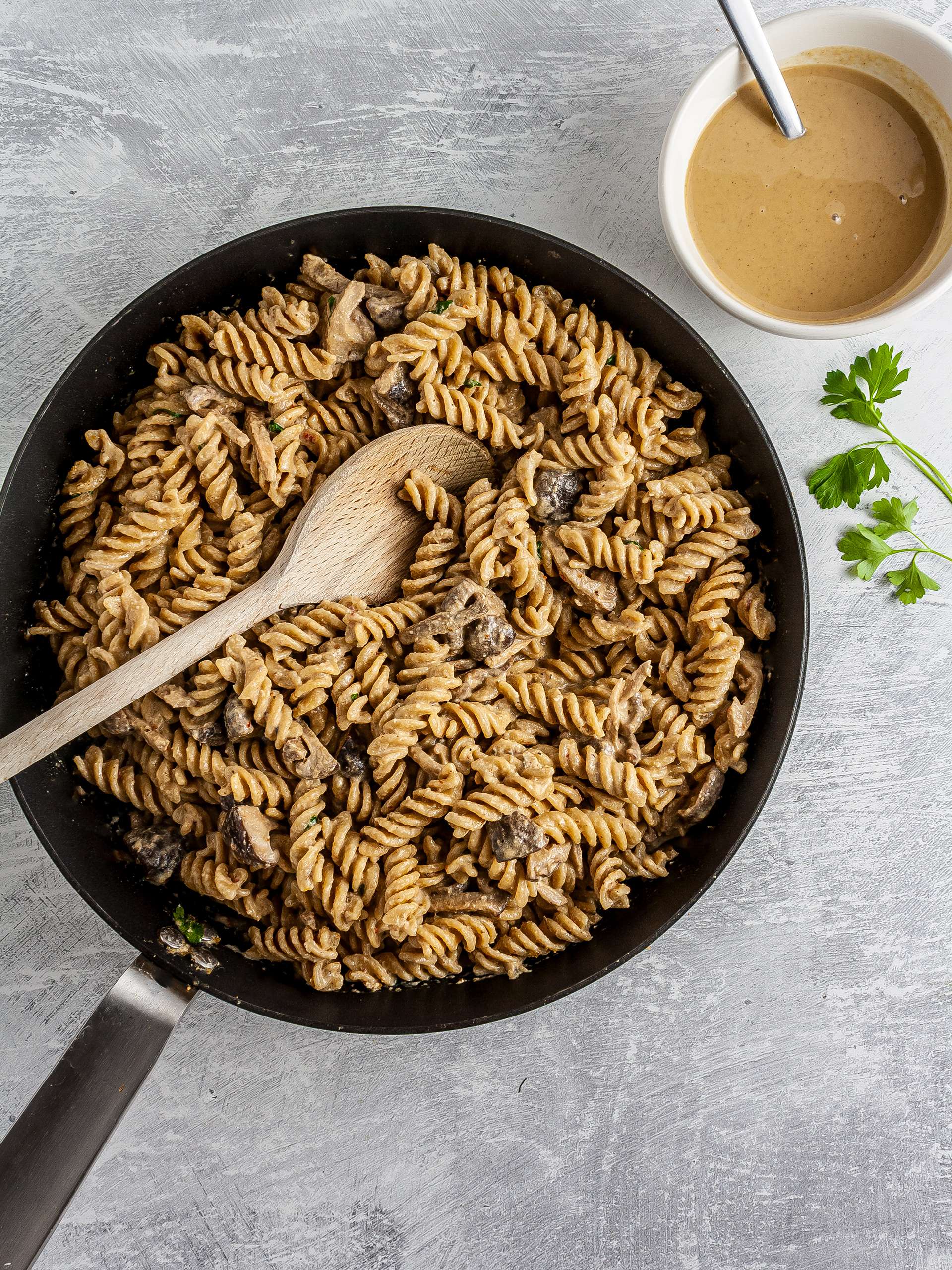 Pasta with tahini sauce in a skillet