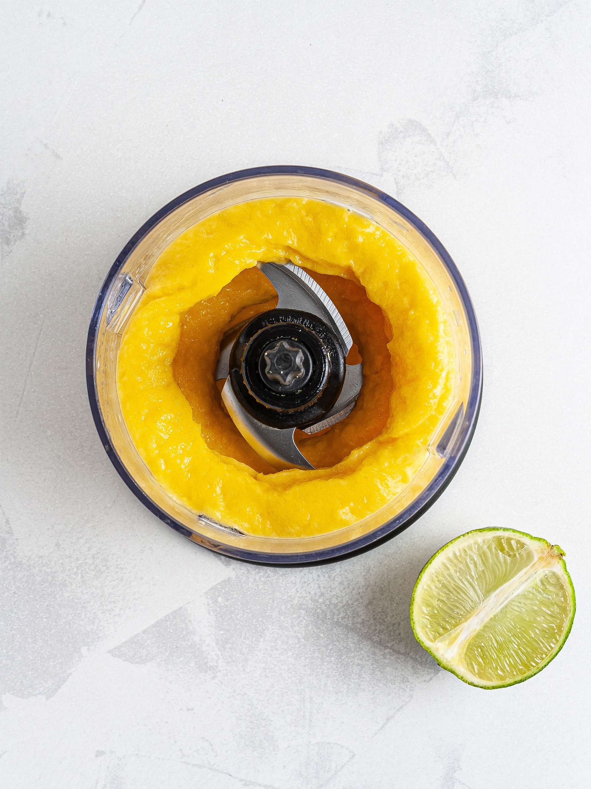 Blended frozen mangoes with lime to make sorbet