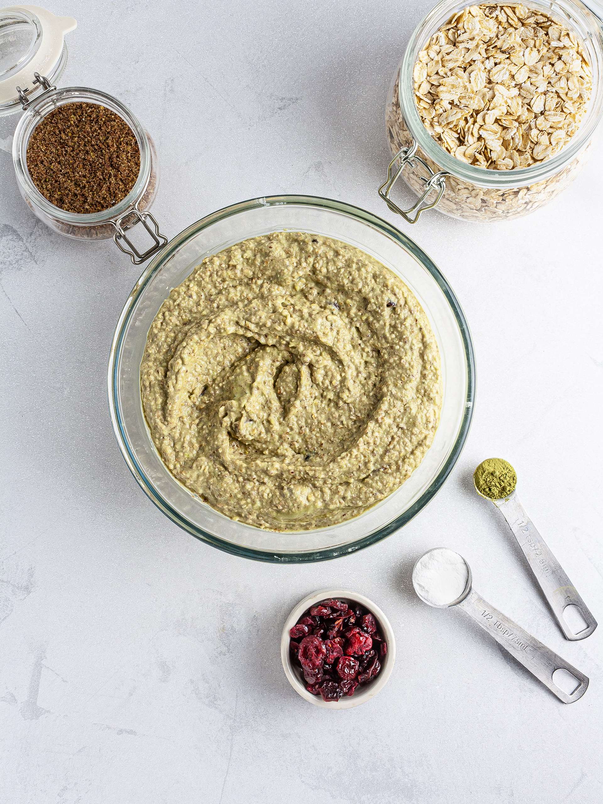 Muffin batter with oats, flaxseeds, cranberries and matcha powder