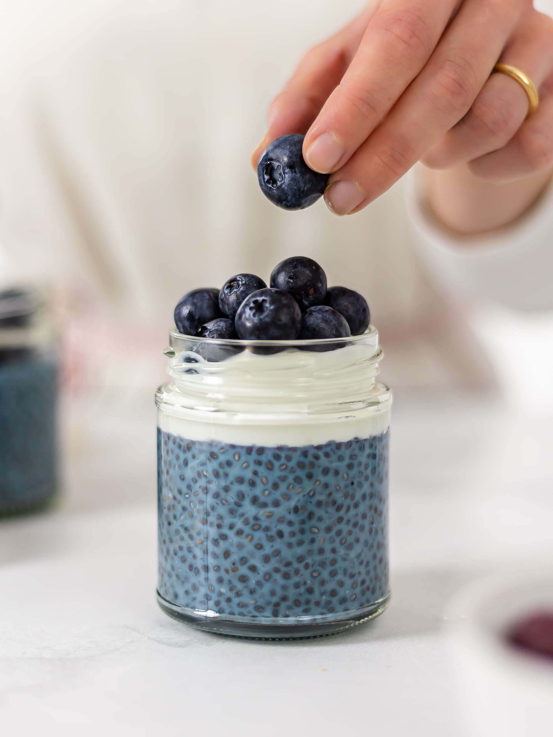 butterfly pea pudding topped with yogurt and berries