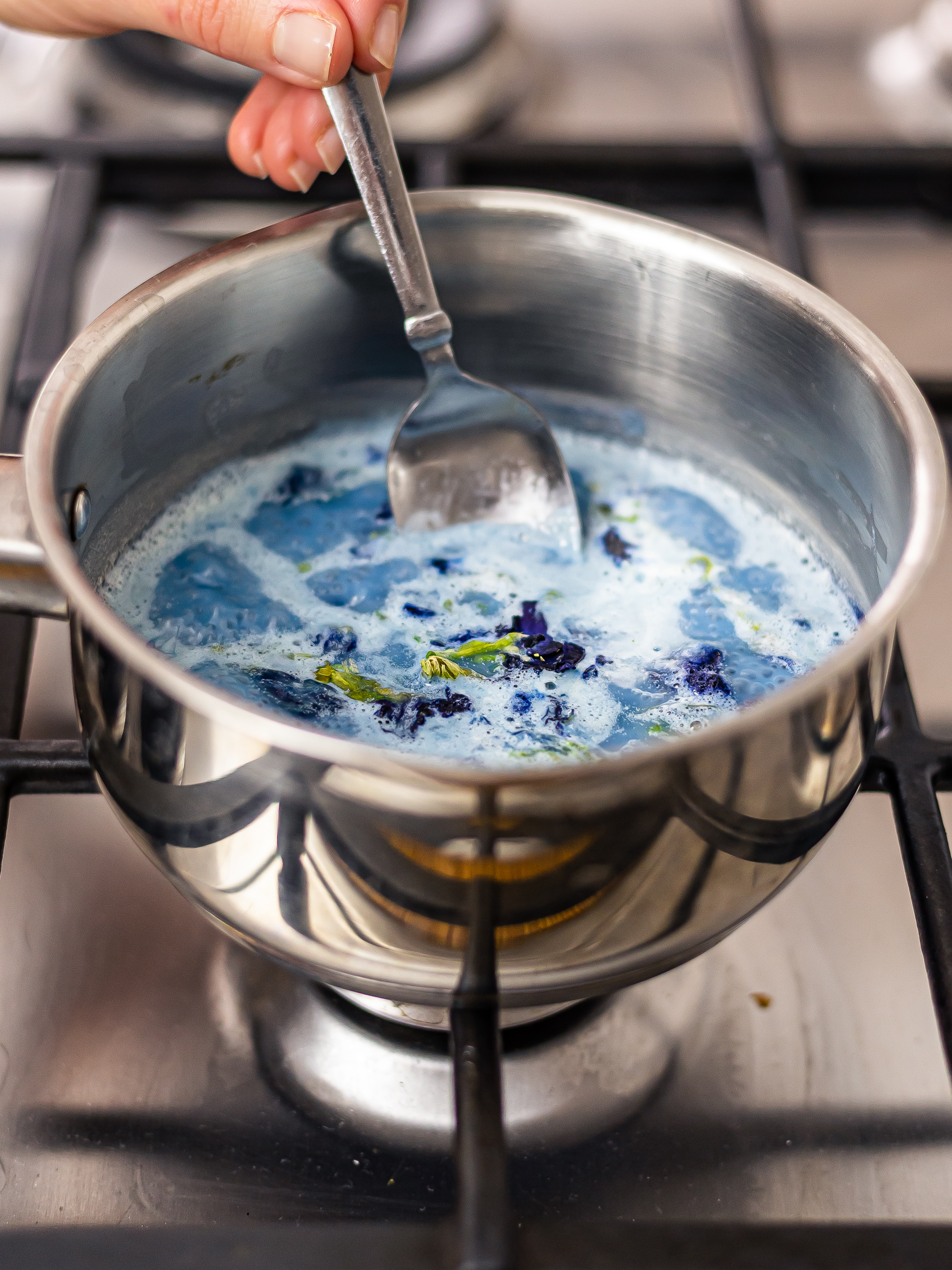 butterfly pea latte simmering in a pot