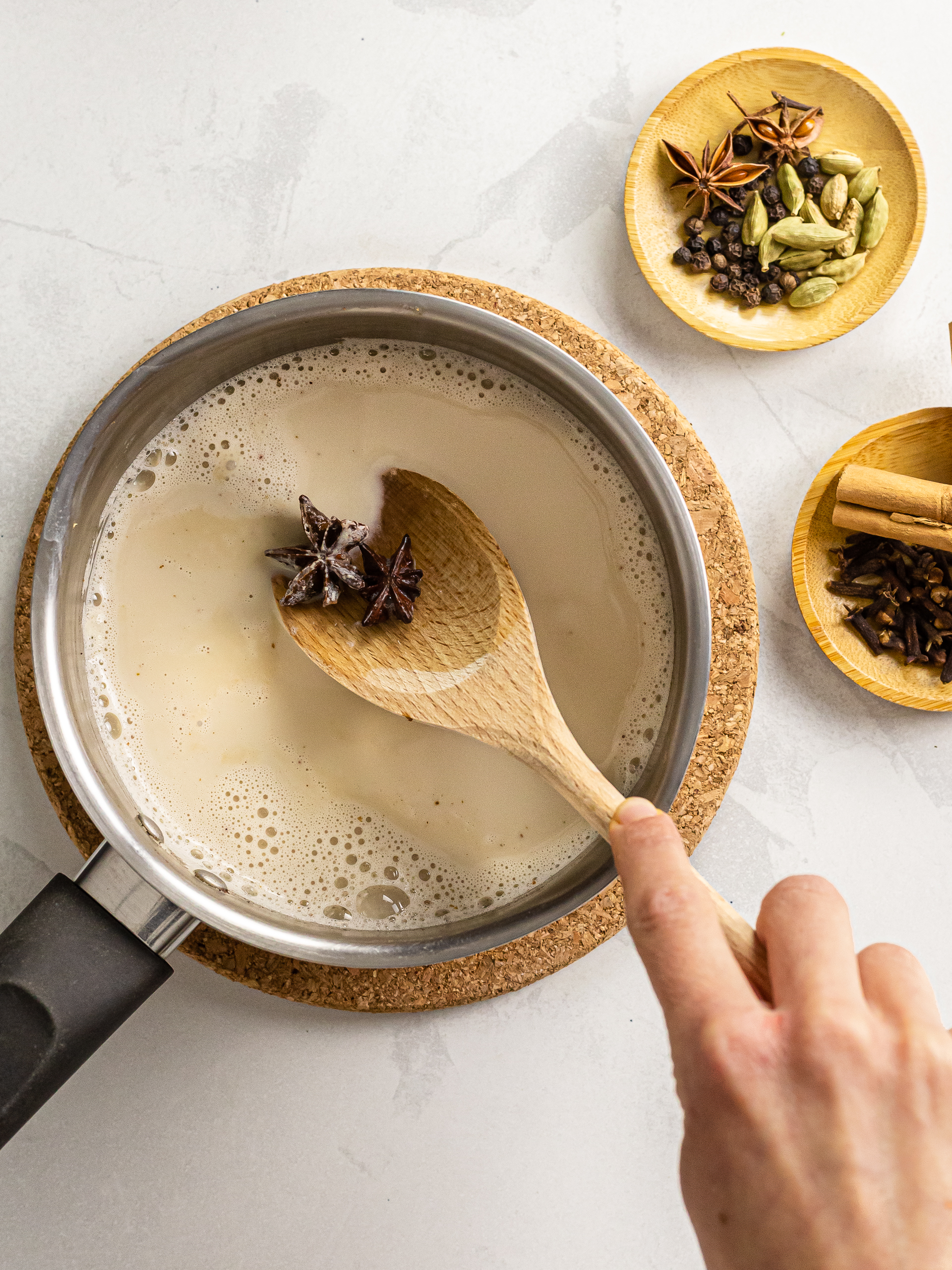 chai spices simmering in oat milk for chai latte