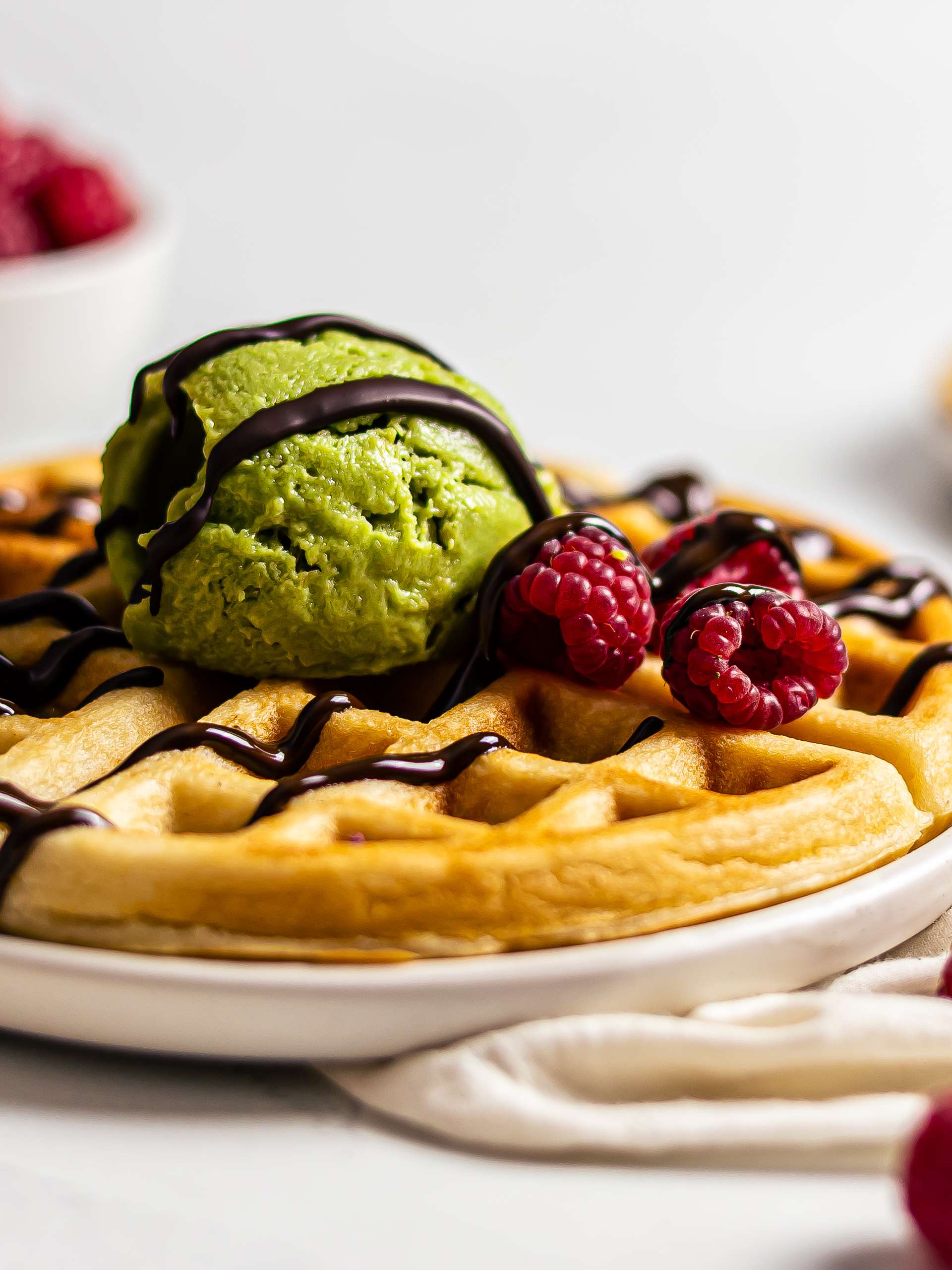 mochi waffles topped with matcha ice cream and berries