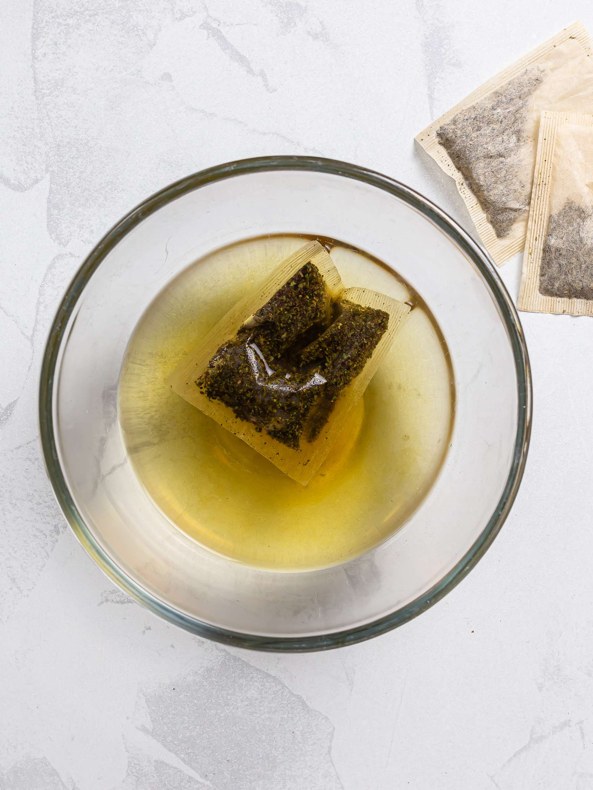 white tea bags steeping in boiling water