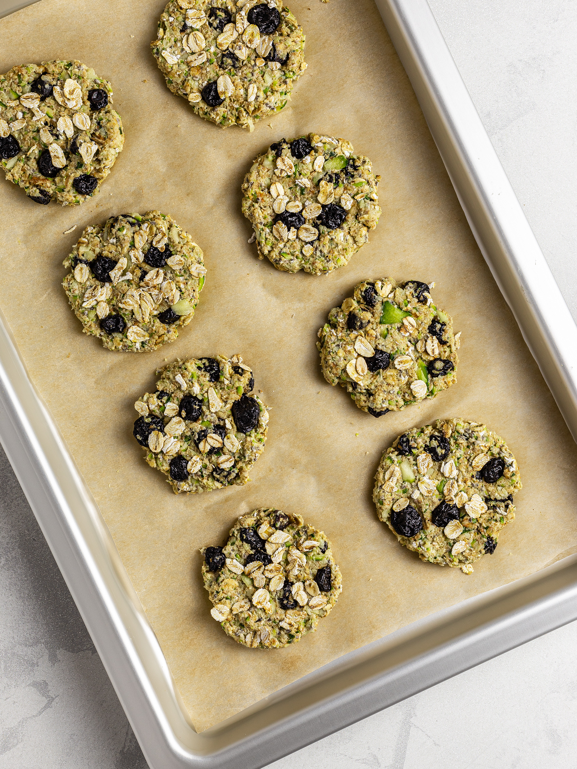 Shaped zucchini cookies on a baking tray