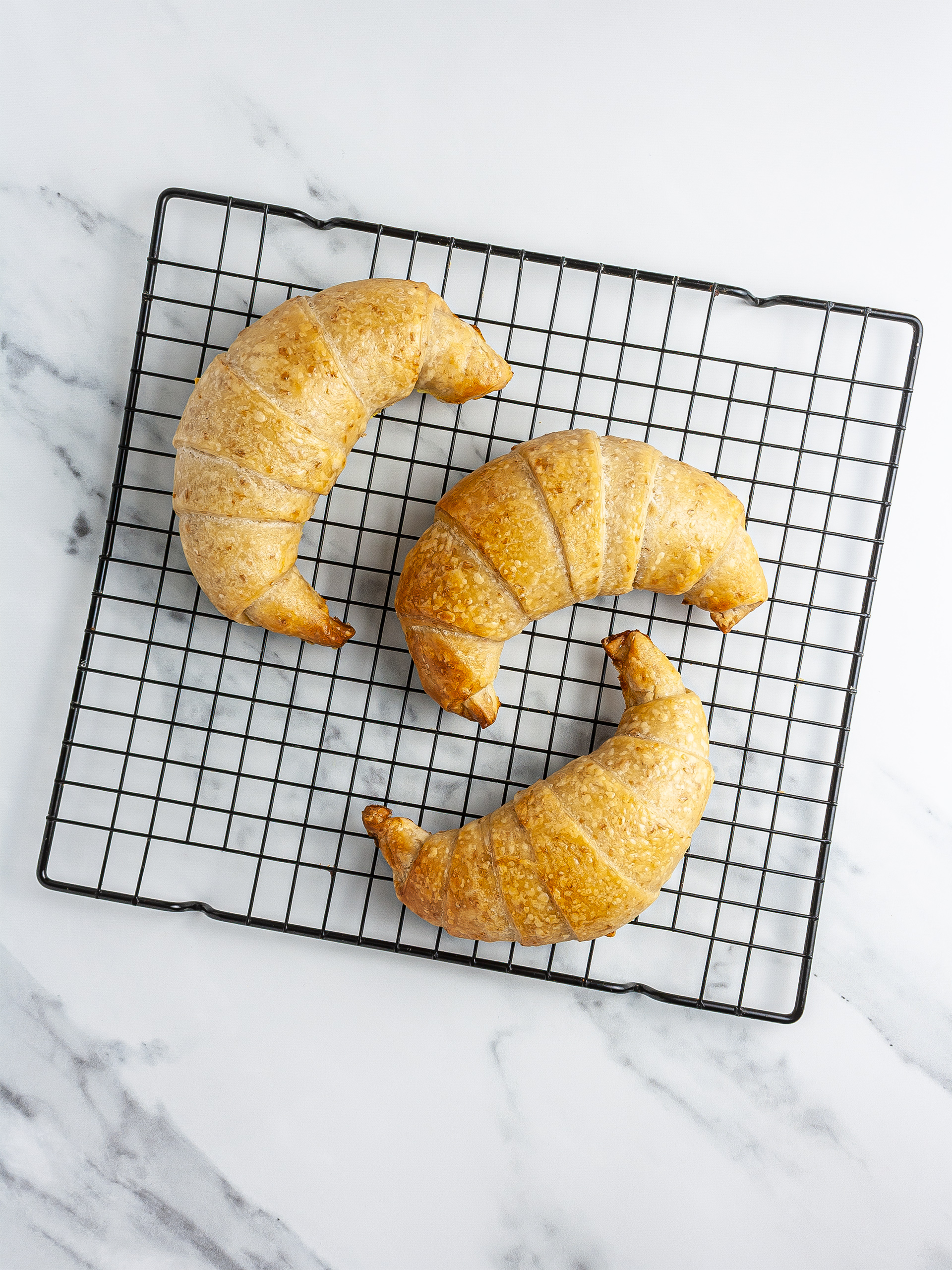 Baked croissants on a rack