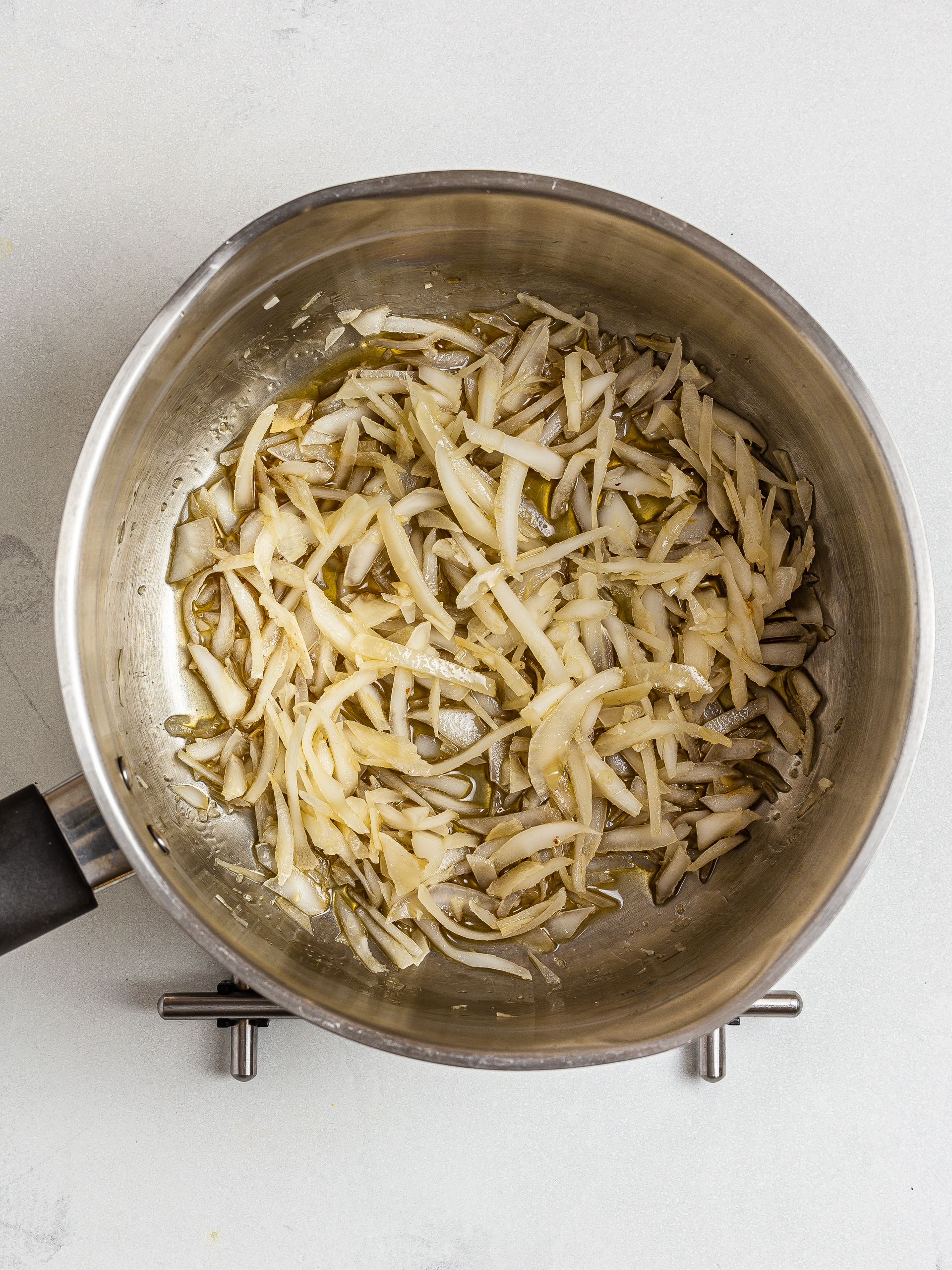 candied coconut with maple syrup in a pot