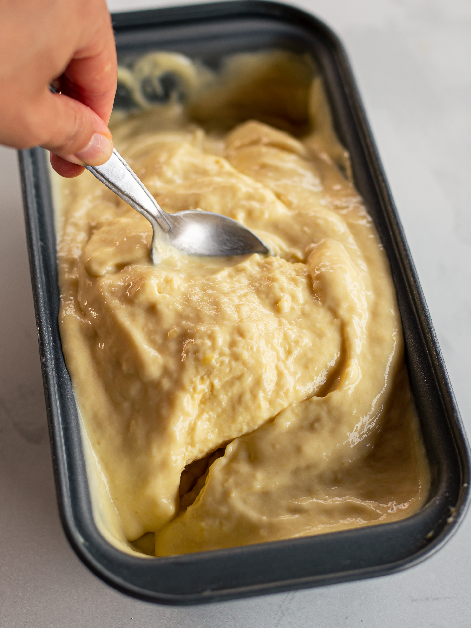 churning homemade jackfruit ice cream by hand